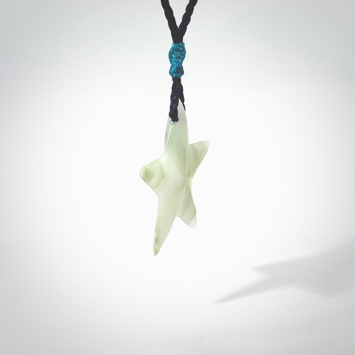 Jadeite star pendant. Star shaped necklace hand made from white Jadeite stone. Delivered on an adjustable blue cord and packaged in a woven kete pouch.