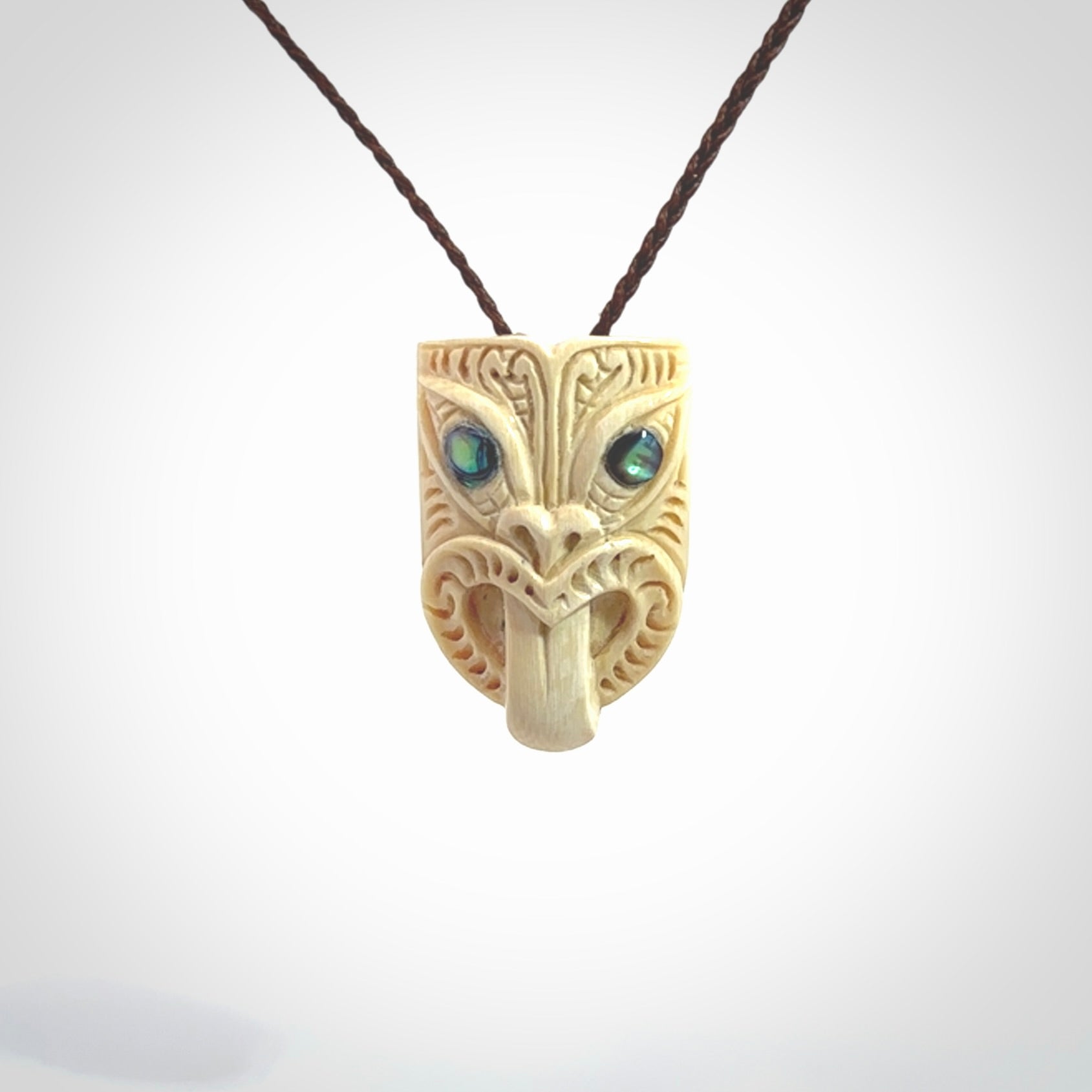 Hand carved Wheku pendant. Carved from woolly mammoth Tusk by NZ Pacific. Hand crafted Mammoth tusk jewellery for sale online. Provided with an adjustable cord and packaged in woven kete pouch.