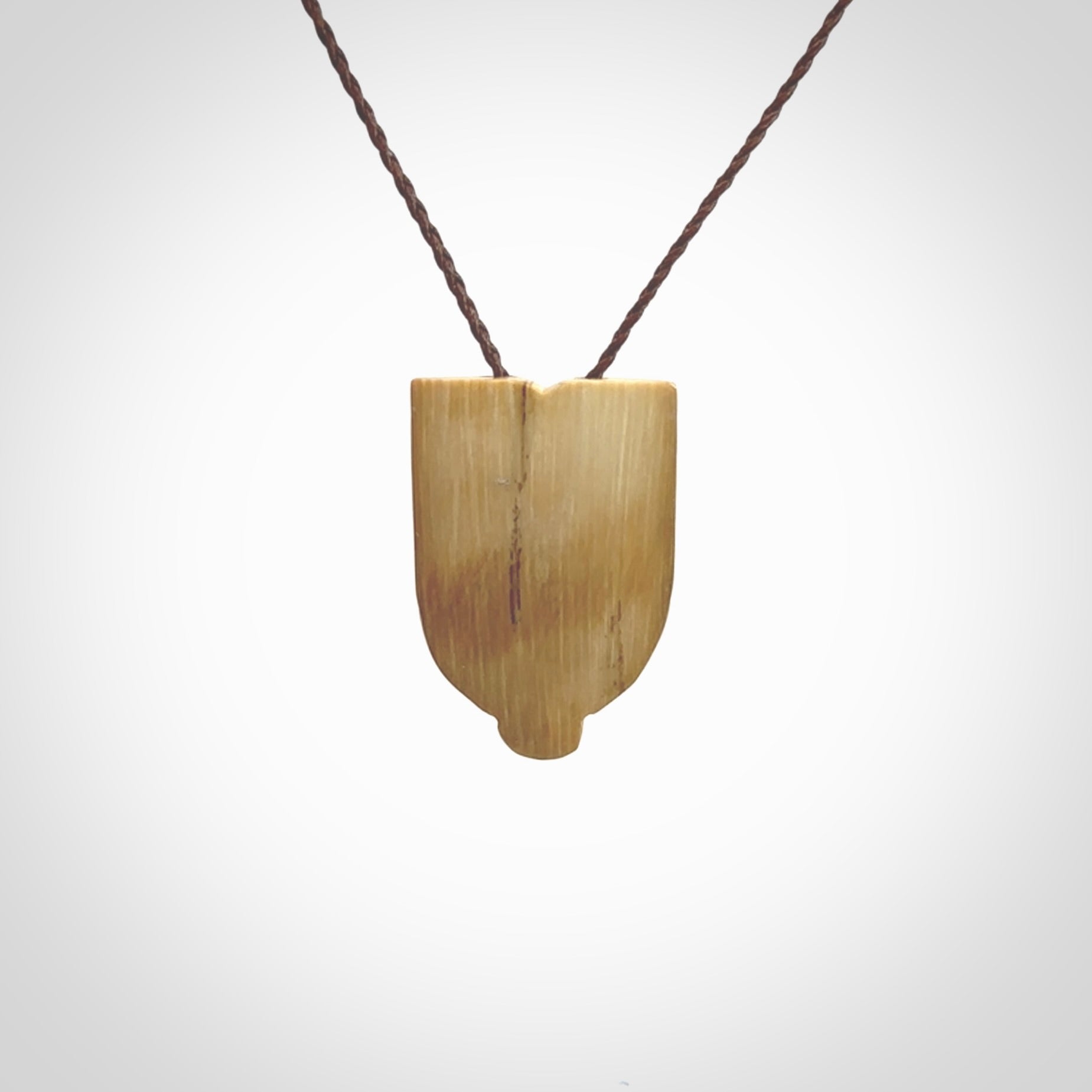 Hand carved Wheku pendant. Carved from woolly mammoth Tusk by NZ Pacific. Hand crafted Mammoth tusk jewellery for sale online. Provided with an adjustable cord and packaged in woven kete pouch.