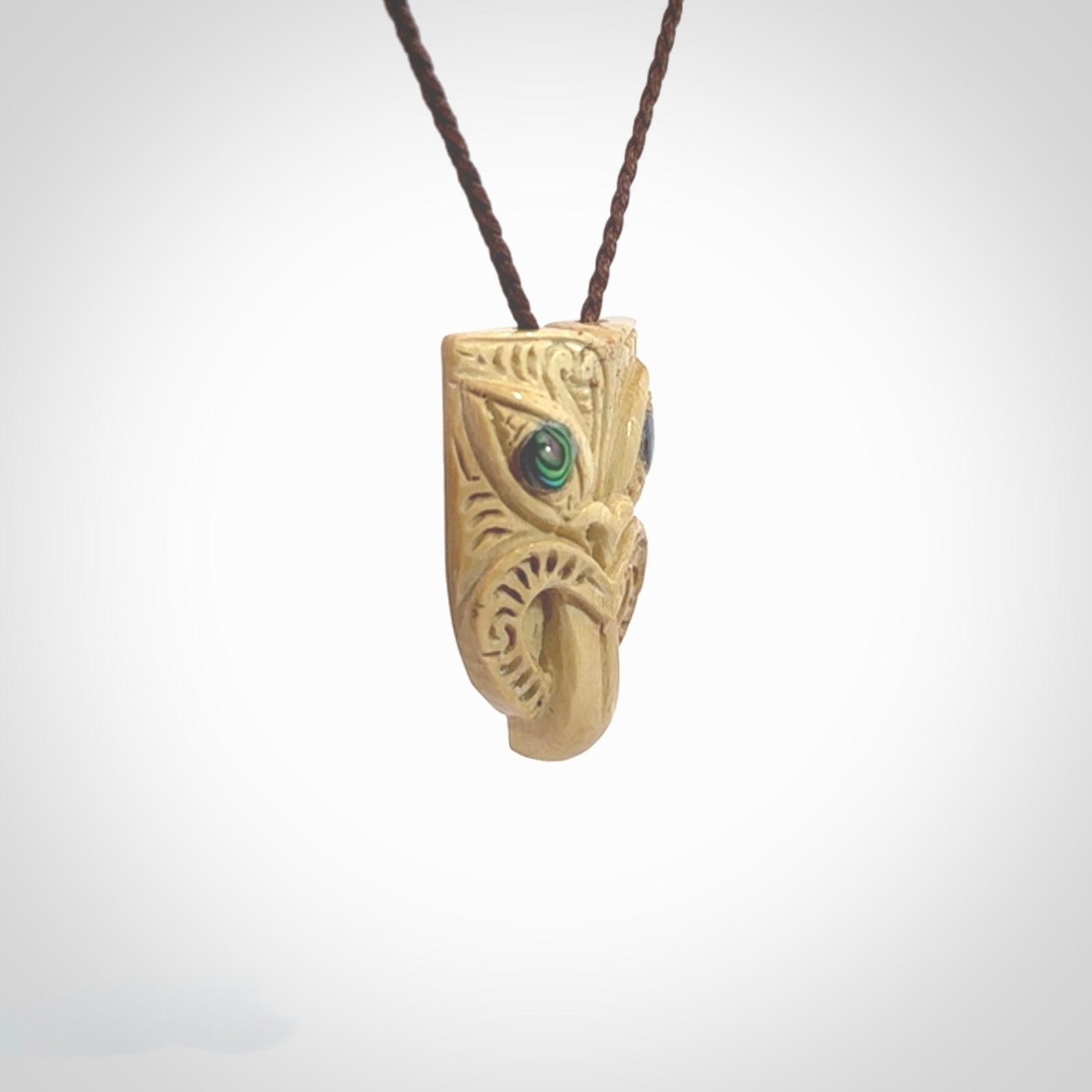 Hand carved Wheku pendant. Carved from woolly mammoth Tusk by NZ Pacific. Hand crafted Mammoth tusk jewellery for sale online. Provided with an adjustable cord and packaged in woven kete pouch.