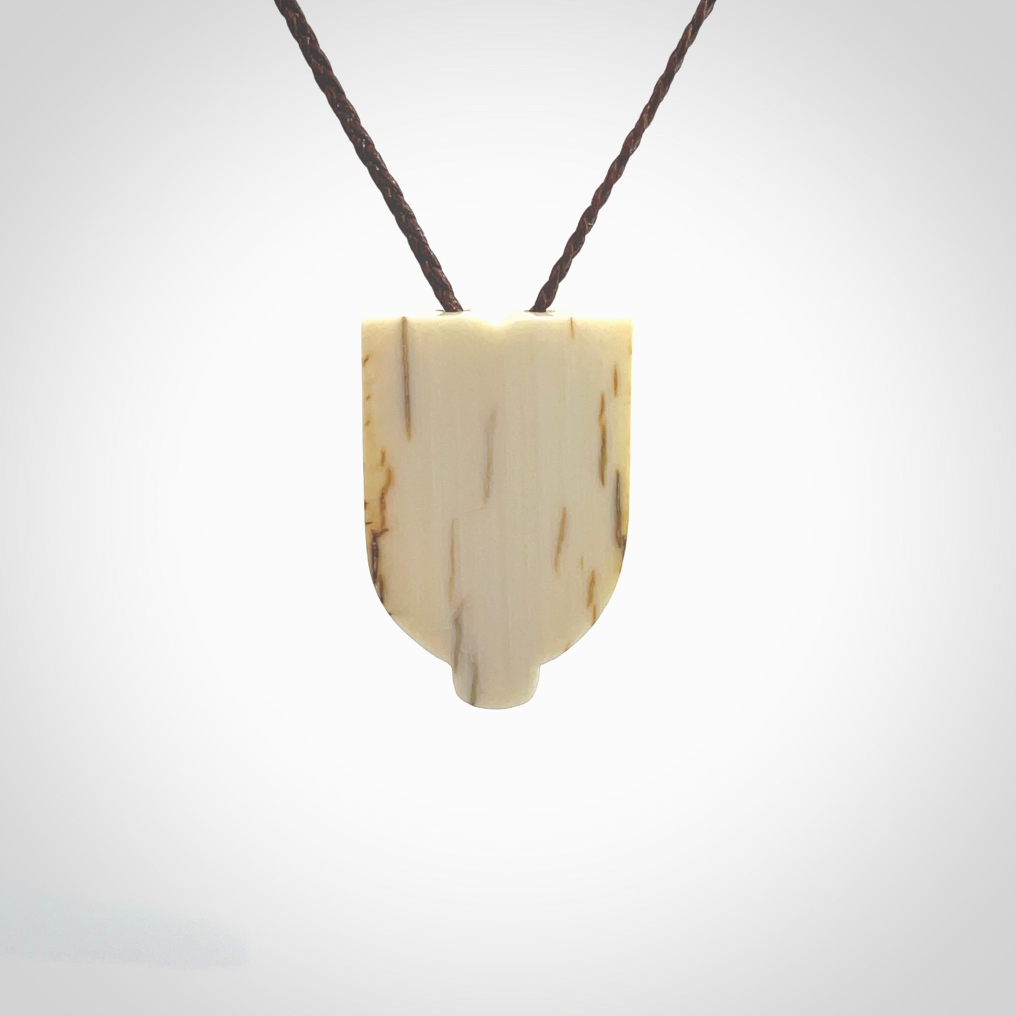 Hand carved Wheku pendant. Carved from woolly mammoth Tusk by NZ Pacific. Hand crafted Mammoth tusk jewellery for sale online. Provided with an adjustable cord and packaged in woven kete pouch