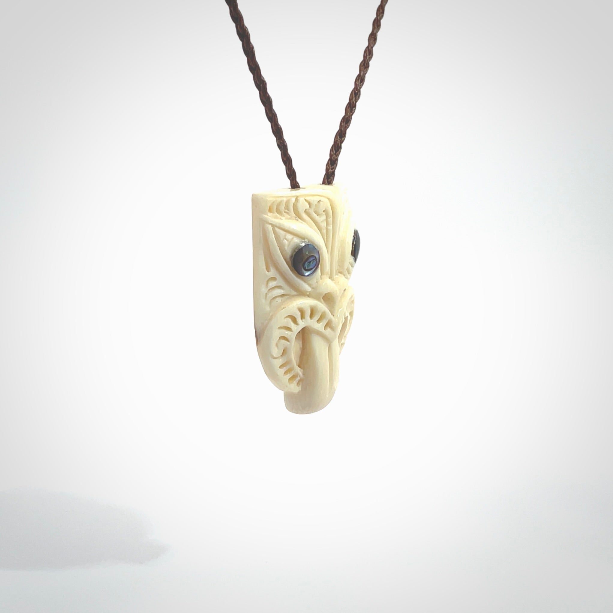 Hand carved Wheku pendant. Carved from woolly mammoth Tusk by NZ Pacific. Hand crafted Mammoth tusk jewellery for sale online. Provided with an adjustable cord and packaged in woven kete pouch