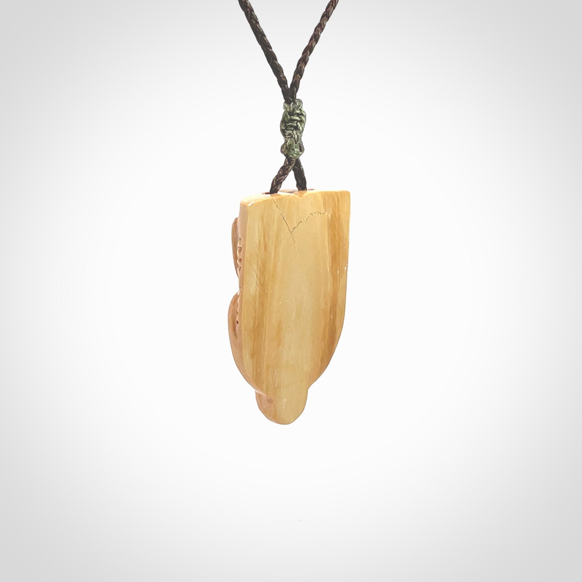 Hand carved Wheku pendant. Carved from woolly mammoth Tusk by NZ Pacific. Hand crafted Mammoth tusk jewellery for sale online. Provided with an adjustable cord and packaged in woven kete pouch