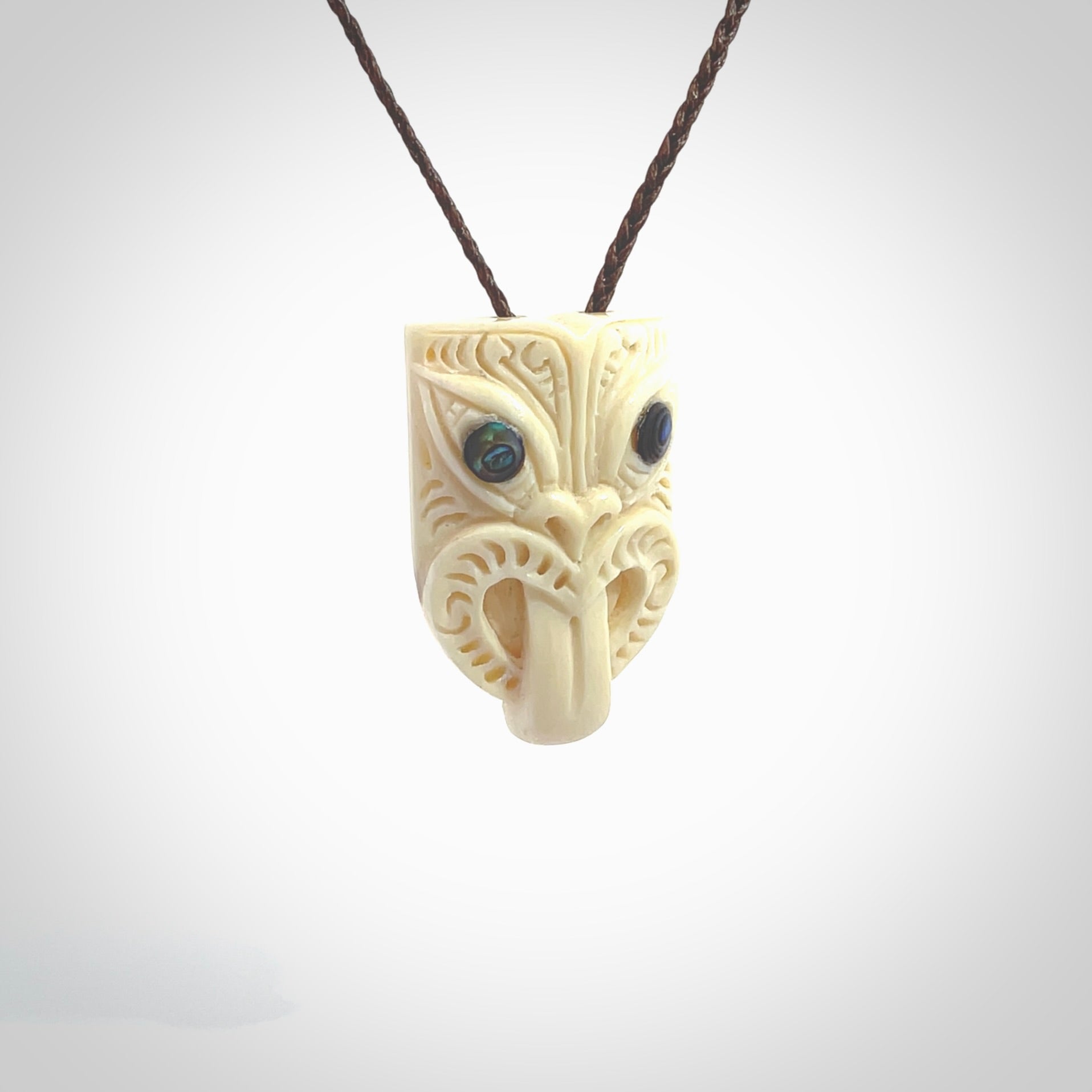 Hand carved Wheku pendant. Carved from woolly mammoth Tusk by NZ Pacific. Hand crafted Mammoth tusk jewellery for sale online. Provided with an adjustable cord and packaged in woven kete pouch