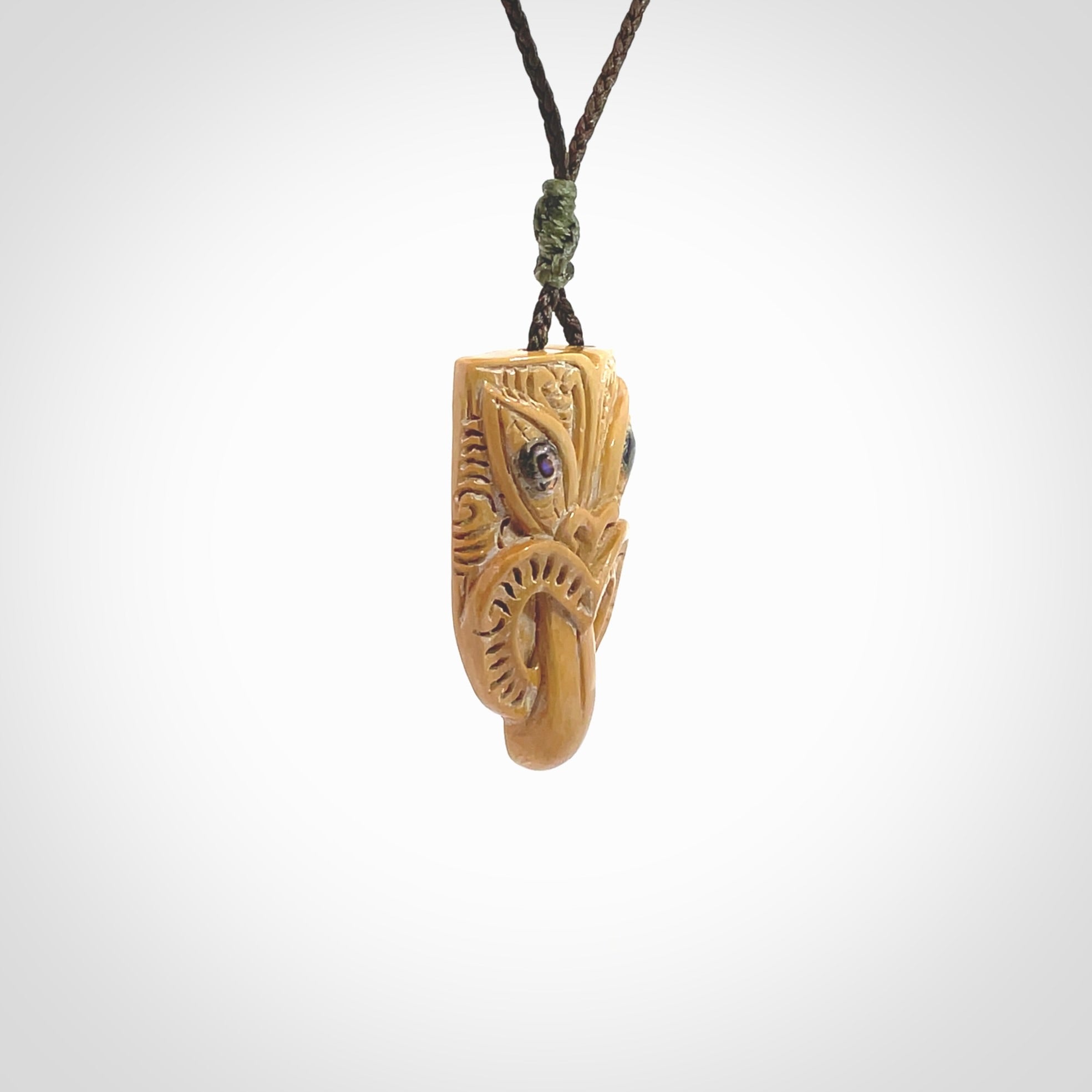 Hand carved Wheku pendant. Carved from woolly mammoth Tusk by NZ Pacific. Hand crafted Mammoth tusk jewellery for sale online. Provided with an adjustable cord and packaged in woven kete pouch