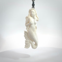 Hand carved large natural bone mermaid pendant. Hand made from real bone. Art to wear. Provided with an adjustable length grey cord and packaged in a woven kete pouch. Bone mermaid necklace.