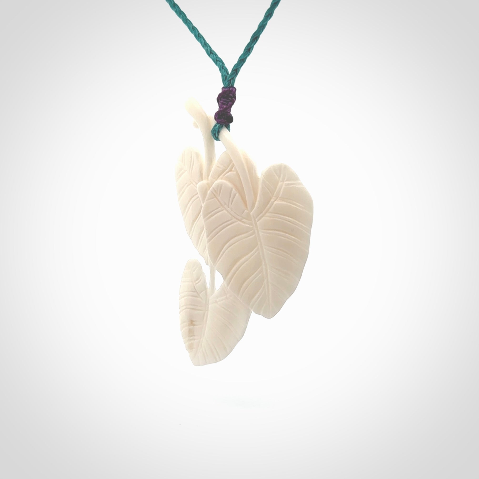 A hand carved large bone water-lily necklace. A beautiful large Nuphar, water-lily pendant carved from bone for NZ Pacific. This is a true piece of wearable art and is provided with an adjustable cord.