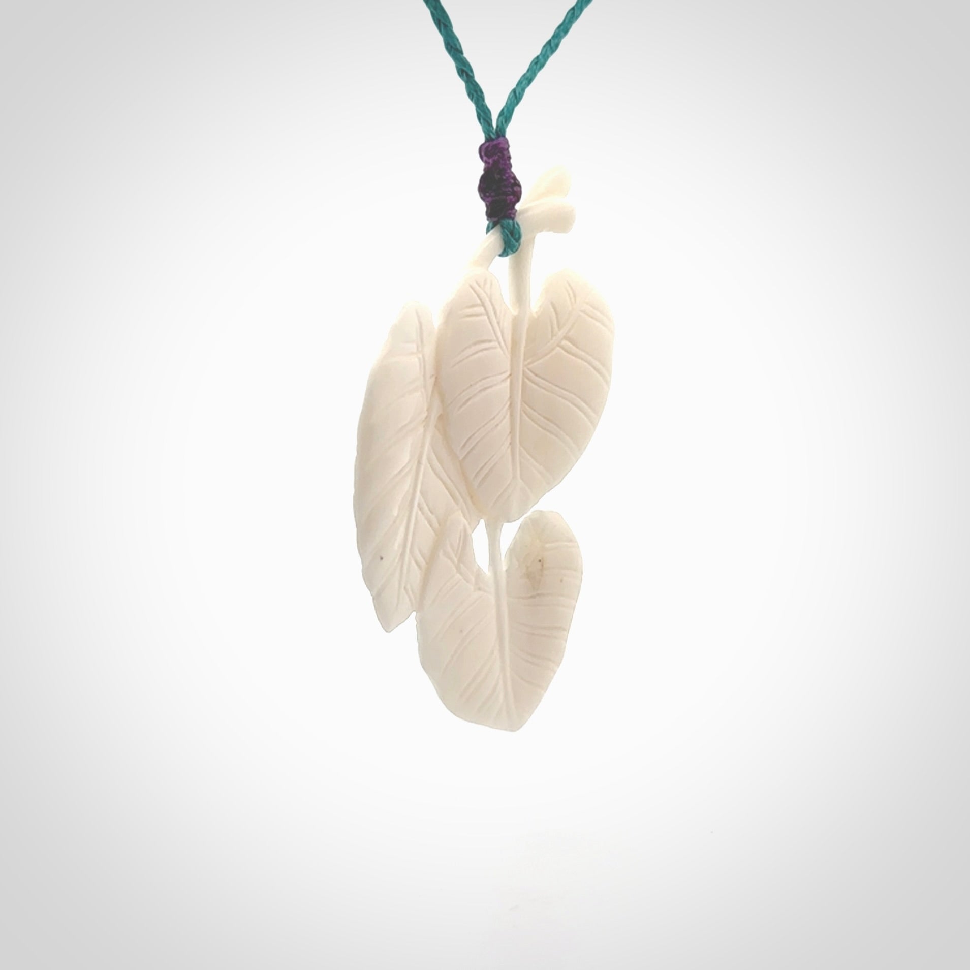 A hand carved large bone water-lily necklace. A beautiful large Nuphar, water-lily pendant carved from bone for NZ Pacific. This is a true piece of wearable art and is provided with an adjustable cord.