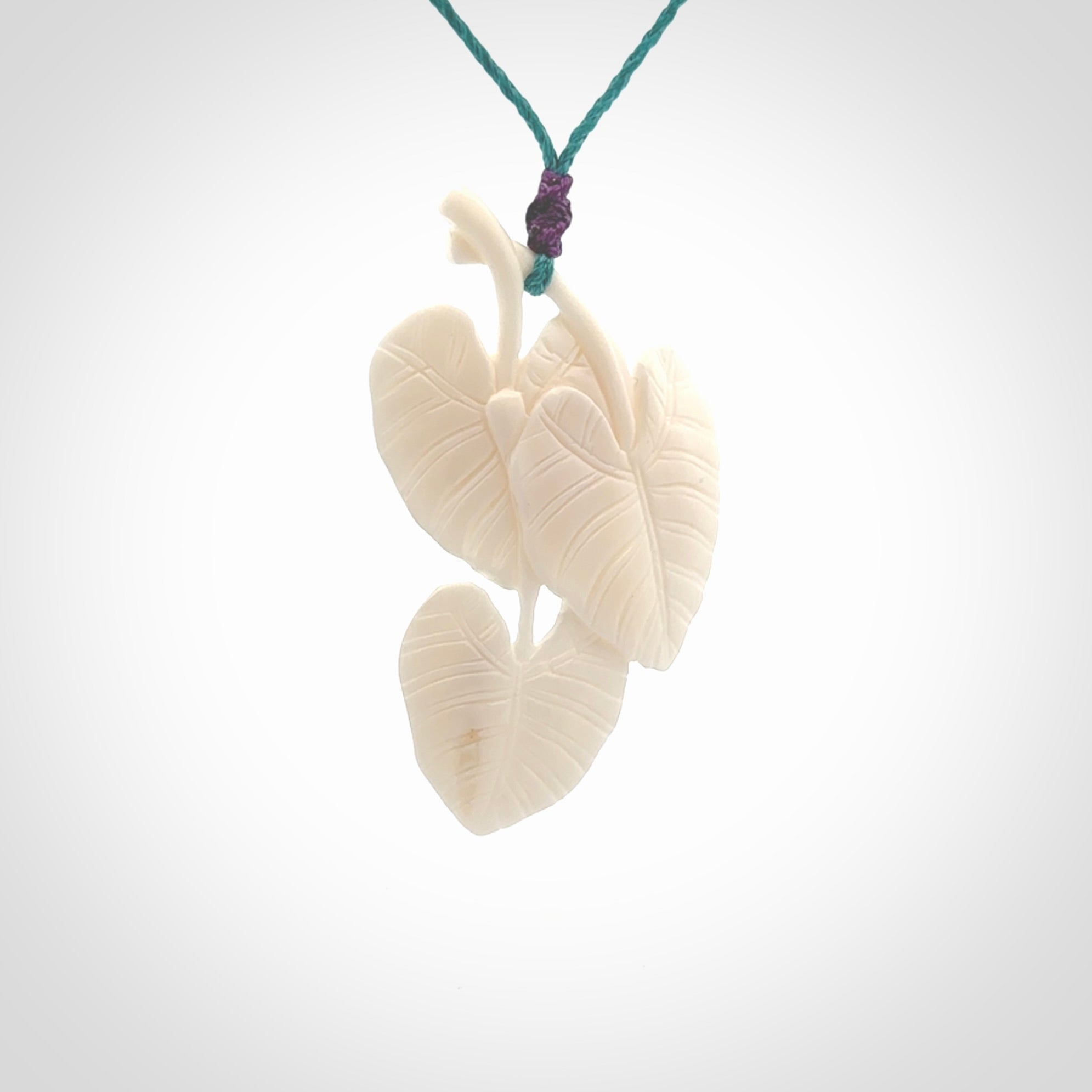 A hand carved large bone water-lily necklace. A beautiful large Nuphar, water-lily pendant carved from bone for NZ Pacific. This is a true piece of wearable art and is provided with an adjustable cord.