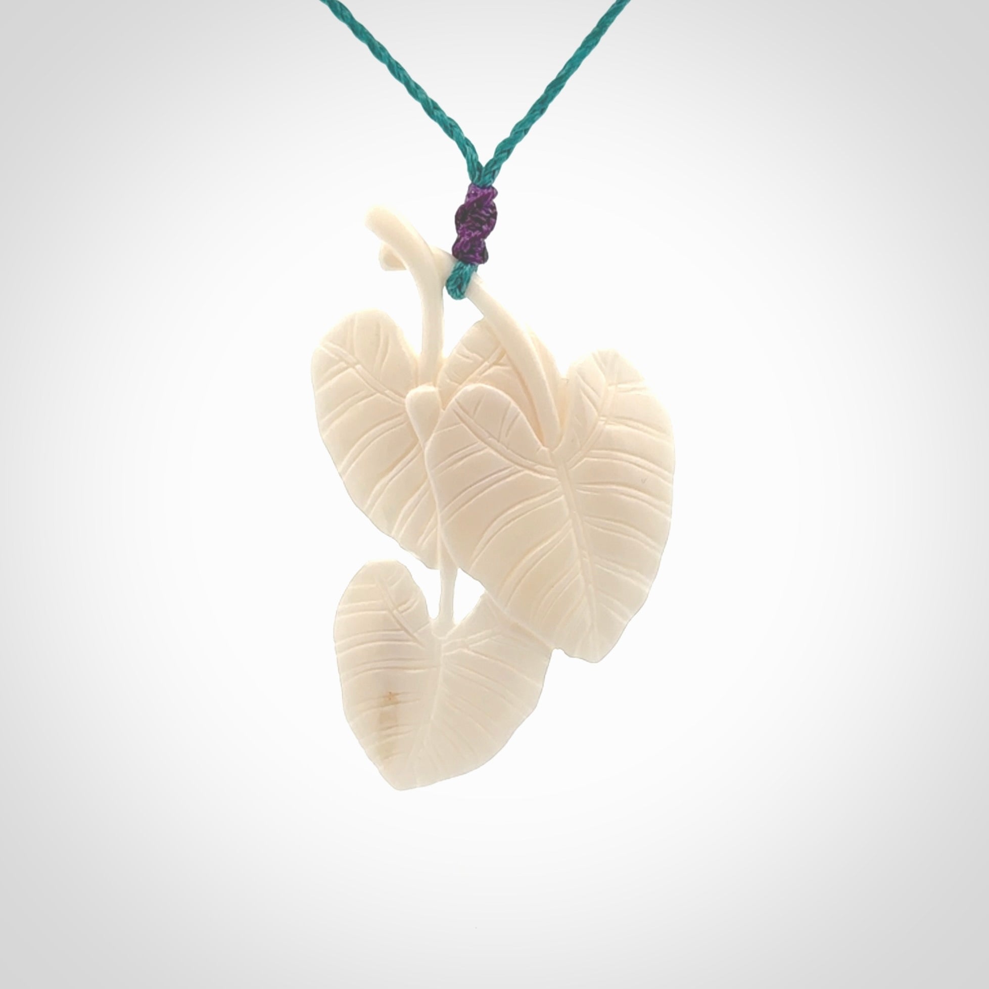 A hand carved large bone water-lily necklace. A beautiful large Nuphar, water-lily pendant carved from bone for NZ Pacific. This is a true piece of wearable art and is provided with an adjustable cord.