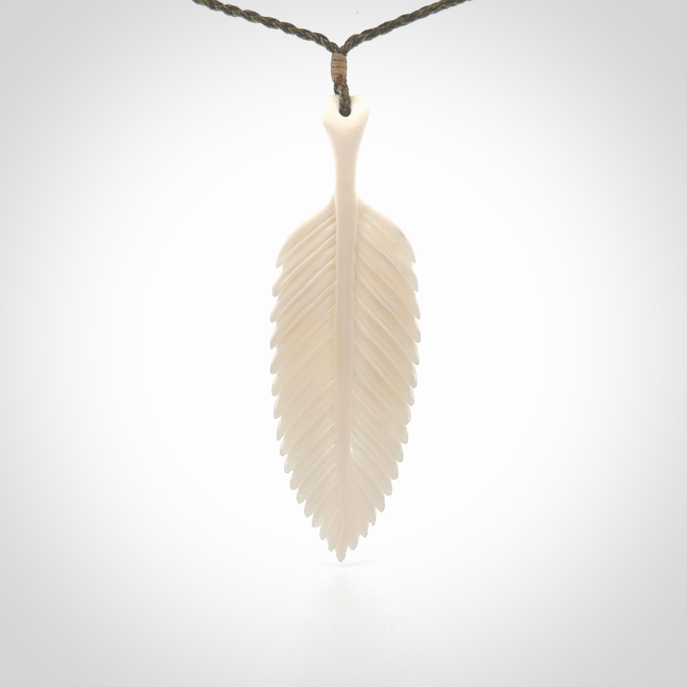 A hand carved large bone fern leaf necklace. A beautiful large fern leaf pendant carved from bone for NZ Pacific. This is a true piece of wearable art and is provided with an adjustable cord.