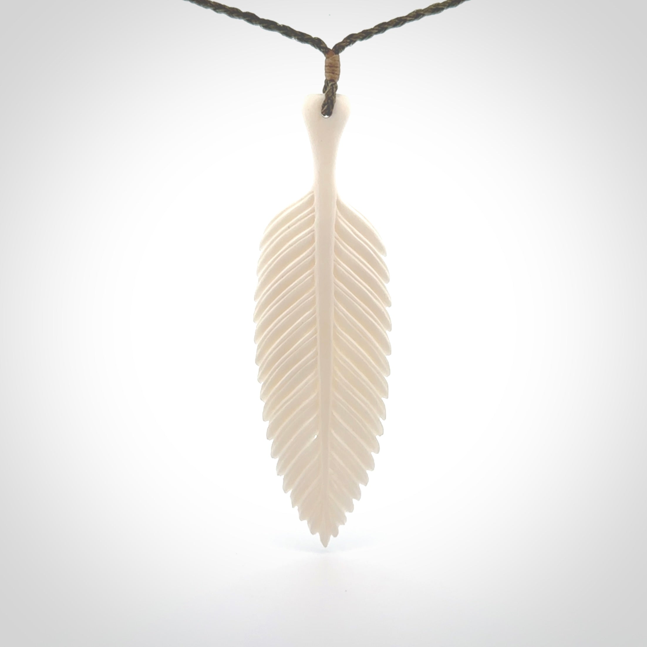 A hand carved large bone fern leaf necklace. A beautiful large fern leaf pendant carved from bone for NZ Pacific. This is a true piece of wearable art and is provided with an adjustable cord.