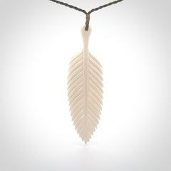 A hand carved large bone fern leaf necklace. A beautiful large fern leaf pendant carved from bone for NZ Pacific. This is a true piece of wearable art and is provided with an adjustable cord.