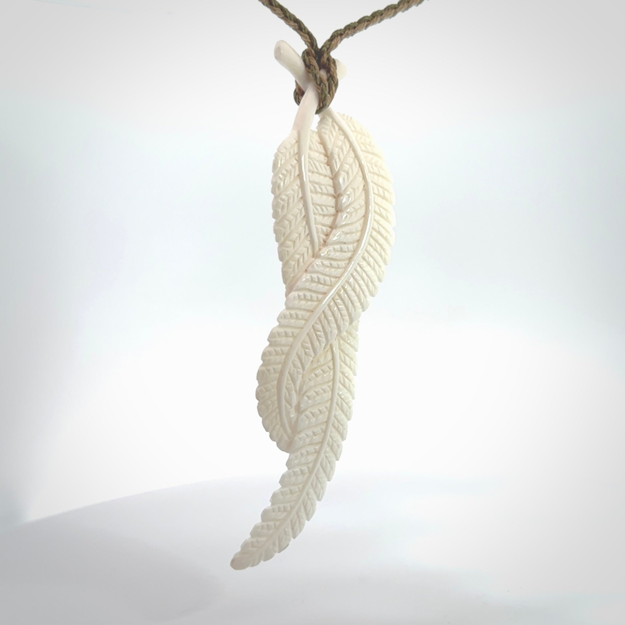 A hand carved large bone double fern leaf necklace. A beautiful large double fern leaf pendant carved from bone for NZ Pacific. This is a true piece of wearable art and is provided with an adjustable cord.