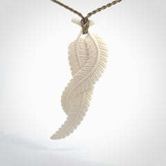 A hand carved large bone double fern leaf necklace. A beautiful large double fern leaf pendant carved from bone for NZ Pacific. This is a true piece of wearable art and is provided with an adjustable cord.