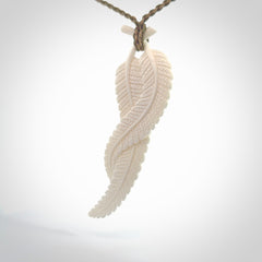 A hand carved large bone double fern leaf necklace. A beautiful large double fern leaf pendant carved from bone for NZ Pacific. This is a true piece of wearable art and is provided with an adjustable cord.