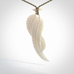 A hand carved large bone double fern leaf necklace. A beautiful large double fern leaf pendant carved from bone for NZ Pacific. This is a true piece of wearable art and is provided with an adjustable cord.