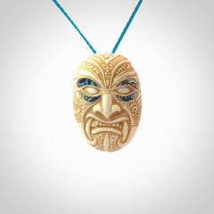 This picture shows a hand carved face pendant. It is carved from bone with paua shell and although a medium piece, it is a wonderful, delicate piece of jewellery. The cord is hand plaited and adjustable so that you can position the pendant where it suits you best. Delivery is free worldwide.