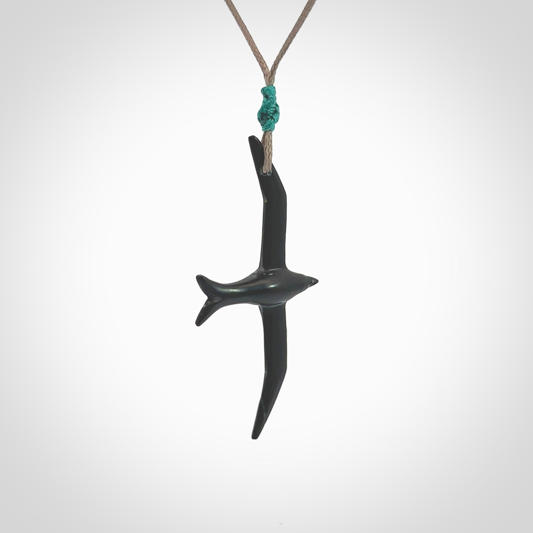 Hand carved black jade petrel bird pendant. Made by NZ Pacific, unique jewellery for sale online. Black Jade petrel bird necklaces with adjustable cords. Delivered with express courier and packaged in a woven kete pouch.