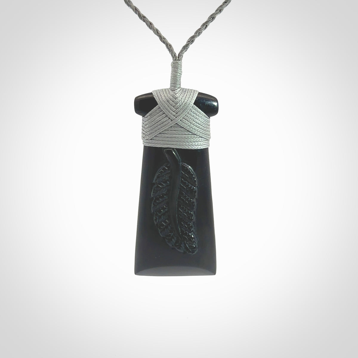 A gorgeous black jade toki pendant, carved with New Zealand's silver fern in relief. This is a pendant we designed for the Rugby World Cup. It is the fern that our national team the All Blacks wear on their jerseys, and the black is the colour of their team uniform. A fantastic and visually striking pendant, designed and carved by NZ Pacific.