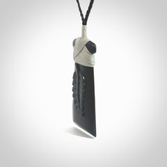 A gorgeous black jade toki pendant, carved with New Zealand's silver fern in relief. This is a pendant we designed for the Rugby World Cup. It is the fern that our national team the All Blacks wear on their jerseys, and the black is the colour of their team uniform. A fantastic and visually striking pendant, designed and carved by NZ Pacific.