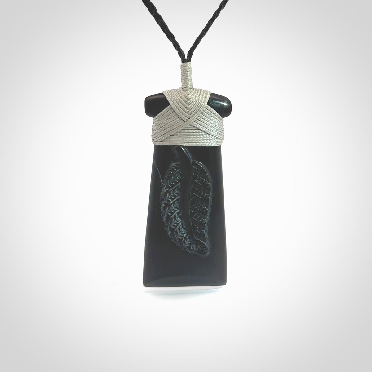 A gorgeous black jade toki pendant, carved with New Zealand's silver fern in relief. This is a pendant we designed for the Rugby World Cup. It is the fern that our national team the All Blacks wear on their jerseys, and the black is the colour of their team uniform. A fantastic and visually striking pendant, designed and carved by NZ Pacific.