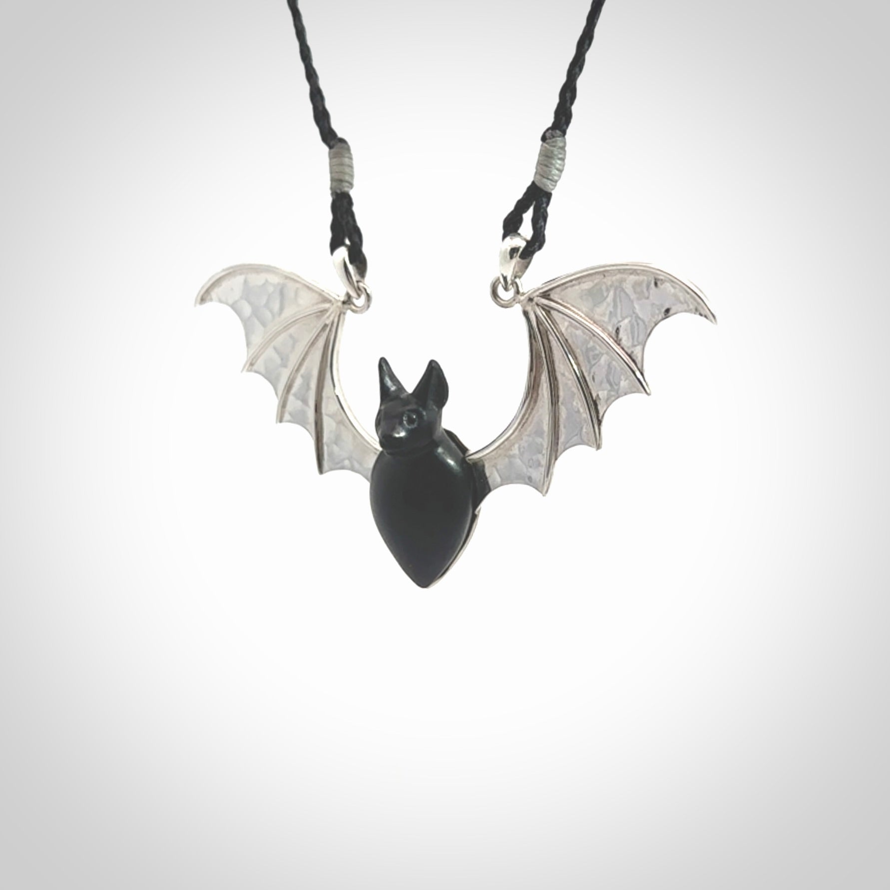 This is a hand carved bat pendant. It is made from Black Jade and Sterling Silver. This is a medium sized necklace and is a very unique, one only, pendant that is a collectors piece. Provided with black adjustable cord.