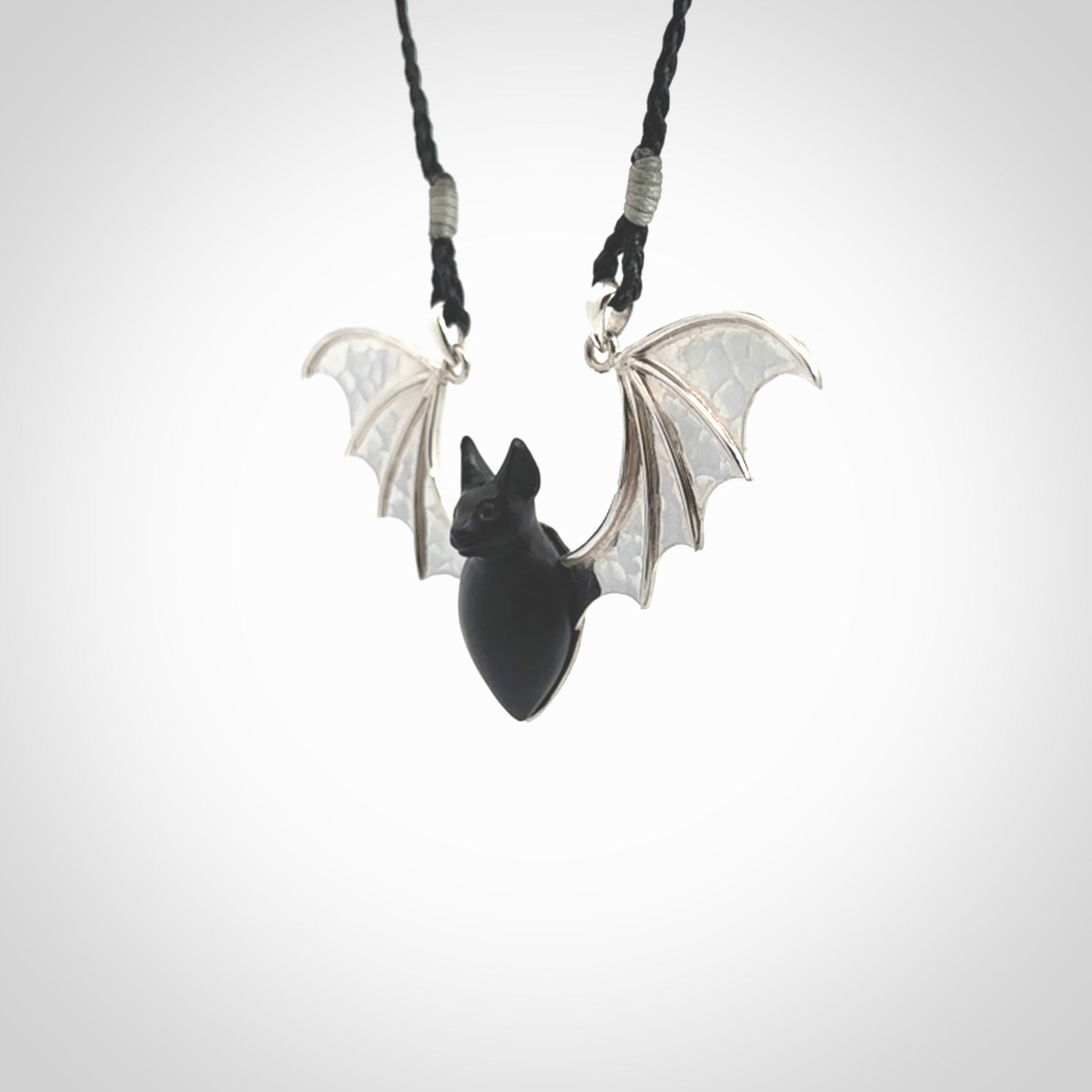 This is a hand carved bat pendant. It is made from Black Jade and Sterling Silver. This is a medium sized necklace and is a very unique, one only, pendant that is a collectors piece. Provided with black adjustable cord.