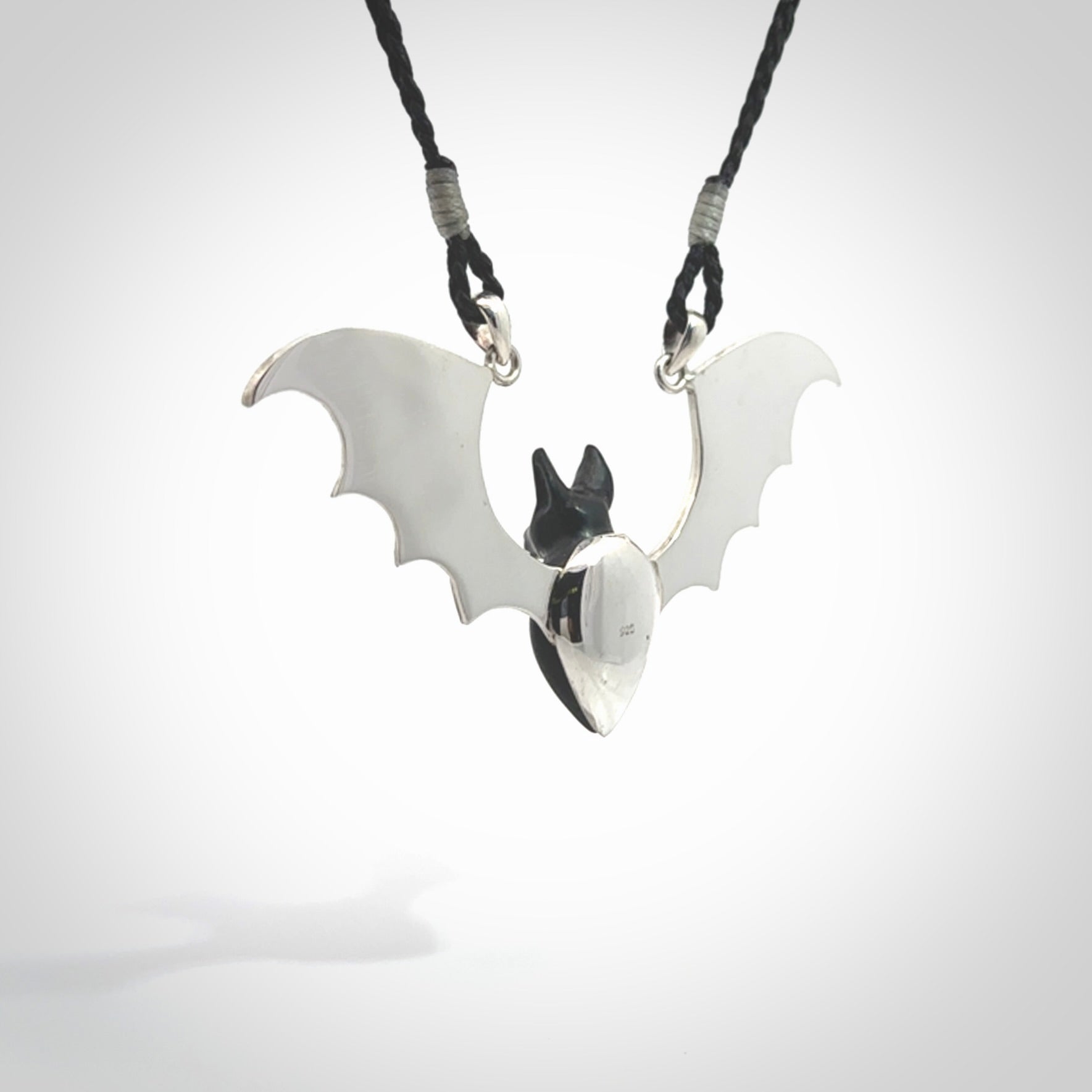 This is a hand carved bat pendant. It is made from Black Jade and Sterling Silver. This is a medium sized necklace and is a very unique, one only, pendant that is a collectors piece. Provided with black adjustable cord.