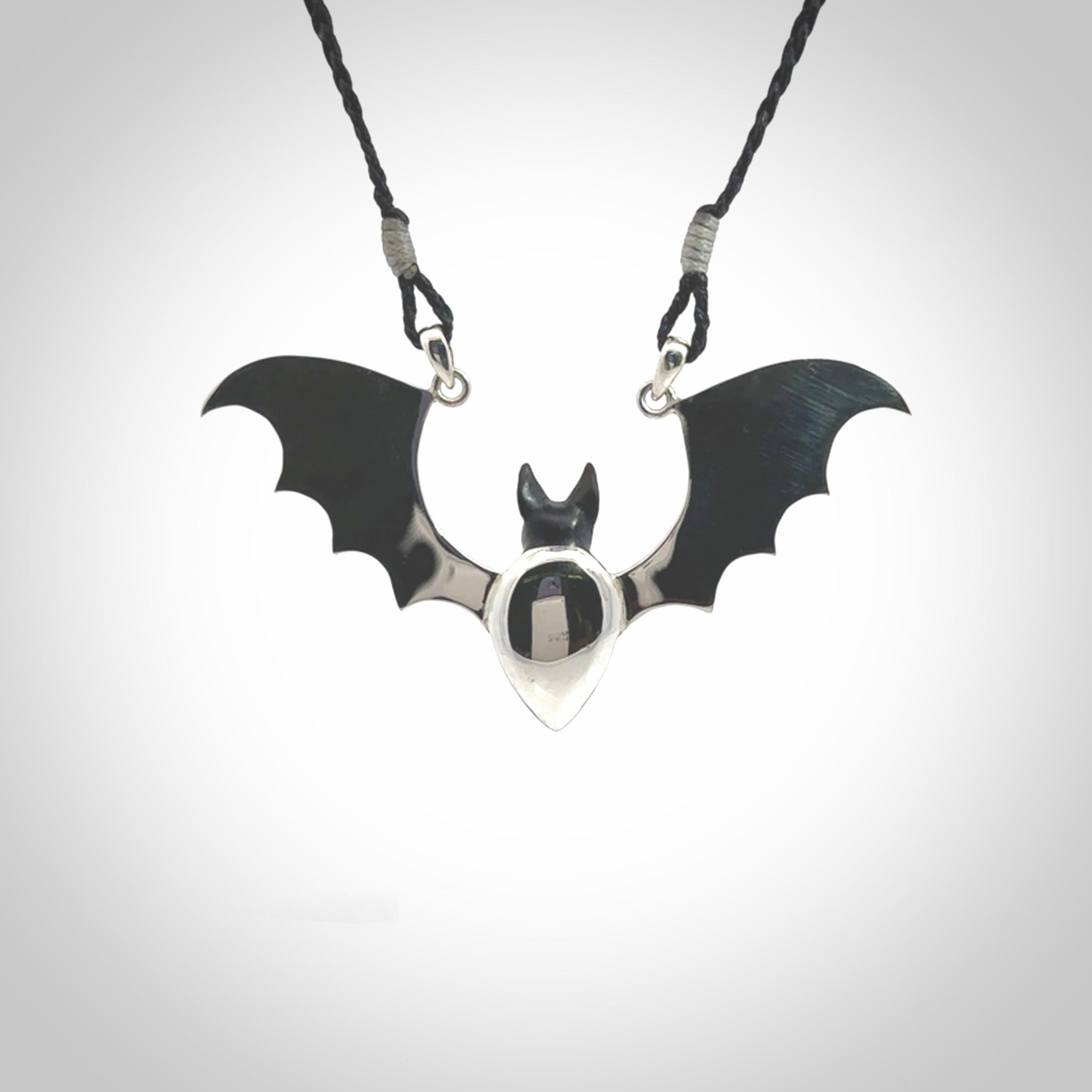 This is a hand carved bat pendant. It is made from Black Jade and Sterling Silver. This is a medium sized necklace and is a very unique, one only, pendant that is a collectors piece. Provided with black adjustable cord.