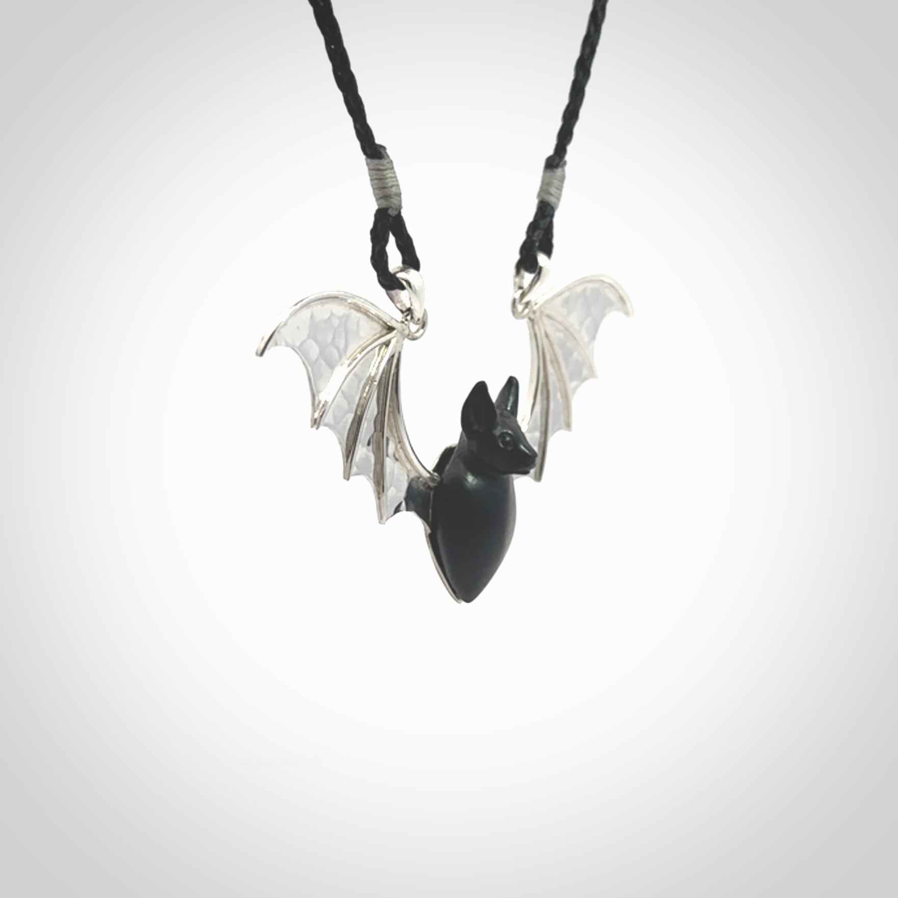 This is a hand carved bat pendant. It is made from Black Jade and Sterling Silver. This is a medium sized necklace and is a very unique, one only, pendant that is a collectors piece. Provided with black adjustable cord.