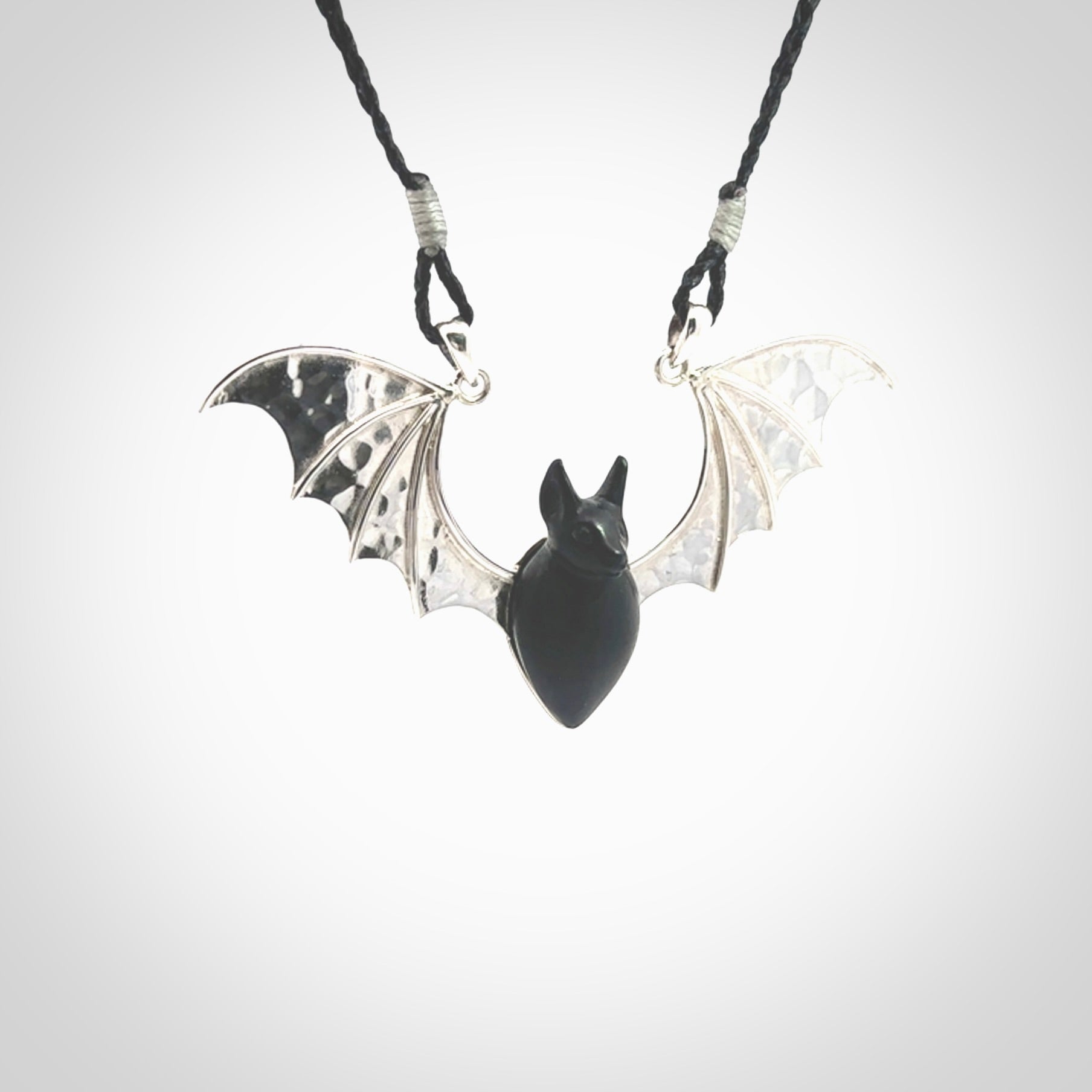 This is a hand carved bat pendant. It is made from Black Jade and Sterling Silver. This is a medium sized necklace and is a very unique, one only, pendant that is a collectors piece. Provided with black adjustable cord.