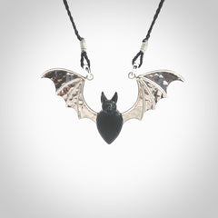 This is a hand carved bat pendant. It is made from Black Jade and Sterling Silver. This is a medium sized necklace and is a very unique, one only, pendant that is a collectors piece. Provided with black adjustable cord.