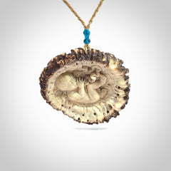 A hand carved baby in the womb pendant made from a piece of deer antler crown. This is a work of art carved in deer antler, bone. We deliver this pendant to you on a plaited tan cord. Delivery with Express Courier is included in the price.