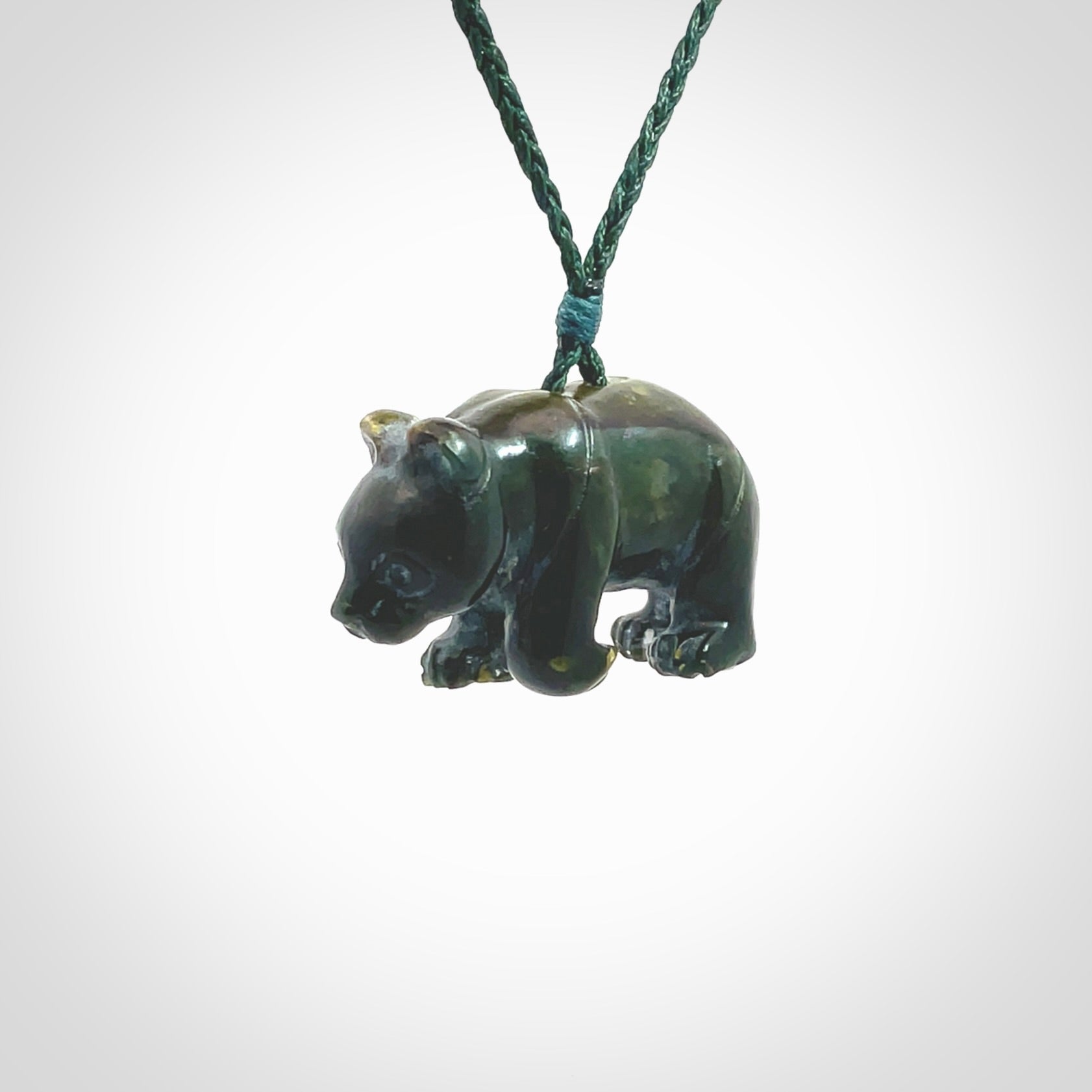 This picture shows a pendant that we designed in New Zealand jade. It is a little green bear that has a walking stance and is carved in detail. A really attractive and eye-catching piece of handmade jewellery. The cord is hand plaited braid in manuka green and the length can be adjusted.