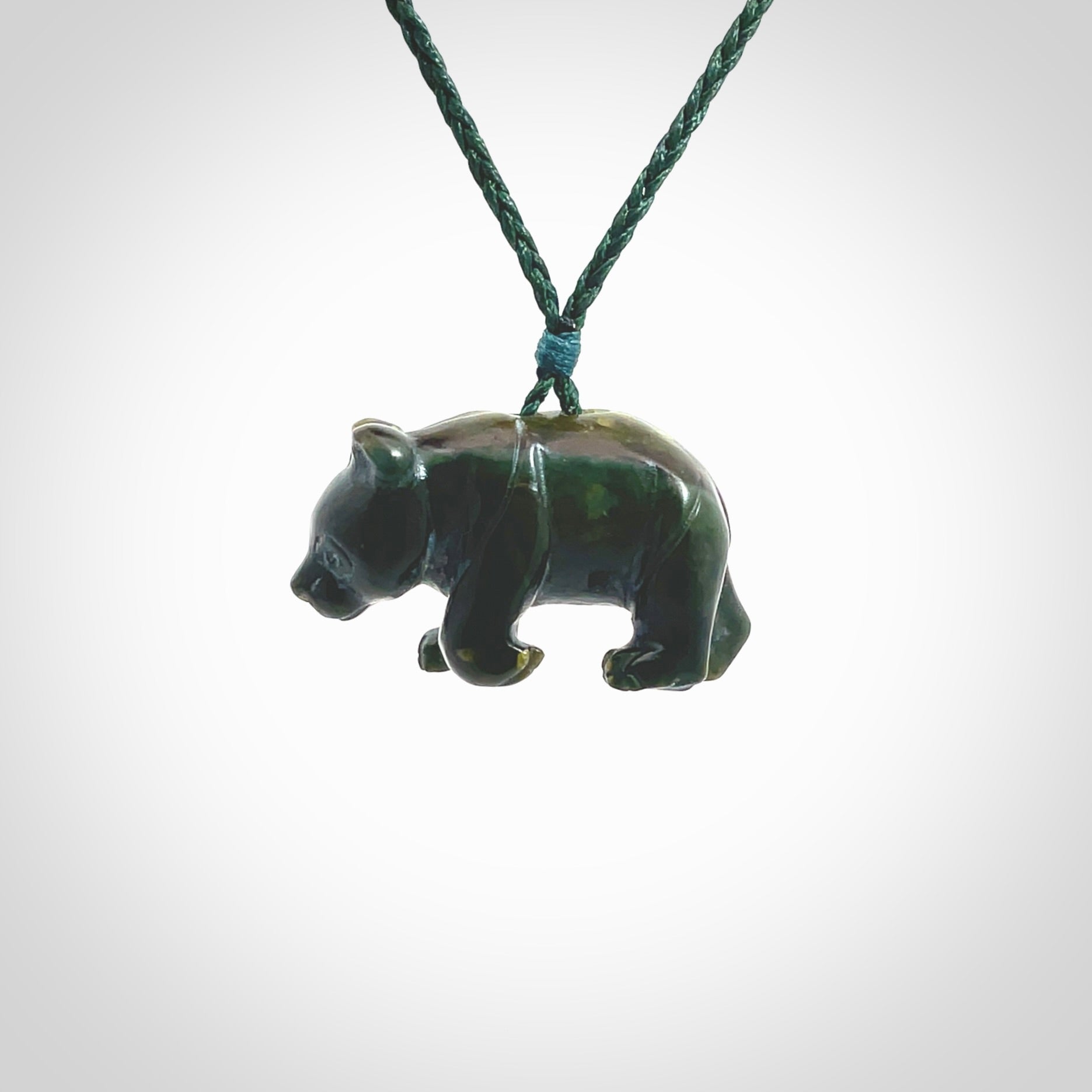 This picture shows a pendant that we designed in New Zealand jade. It is a little green bear that has a walking stance and is carved in detail. A really attractive and eye-catching piece of handmade jewellery. The cord is hand plaited braid in manuka green and the length can be adjusted.