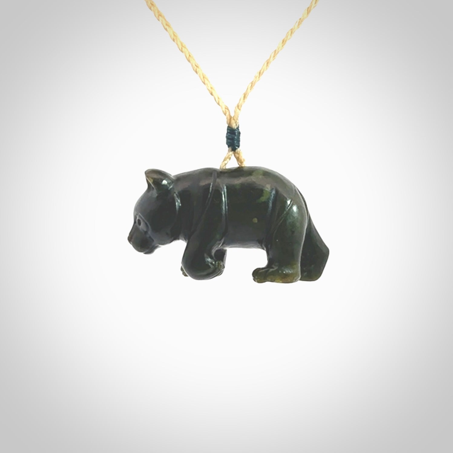 This picture shows a pendant that we designed in New Zealand jade. It is a little green bear that has a walking stance and is carved in detail. A really attractive and eye-catching piece of handmade jewellery. The cord is hand plaited braid and the length can be adjusted.