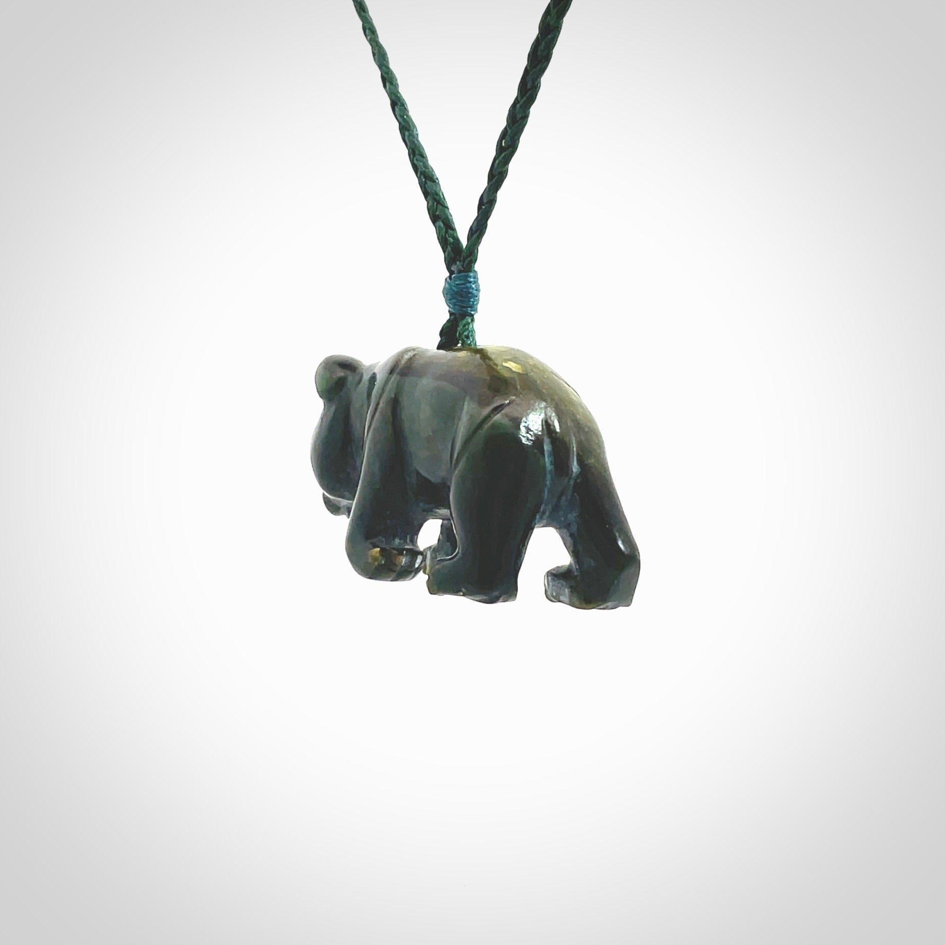 This picture shows a pendant that we designed in New Zealand jade. It is a little green bear that has a walking stance and is carved in detail. A really attractive and eye-catching piece of handmade jewellery. The cord is hand plaited braid in manuka green and the length can be adjusted.