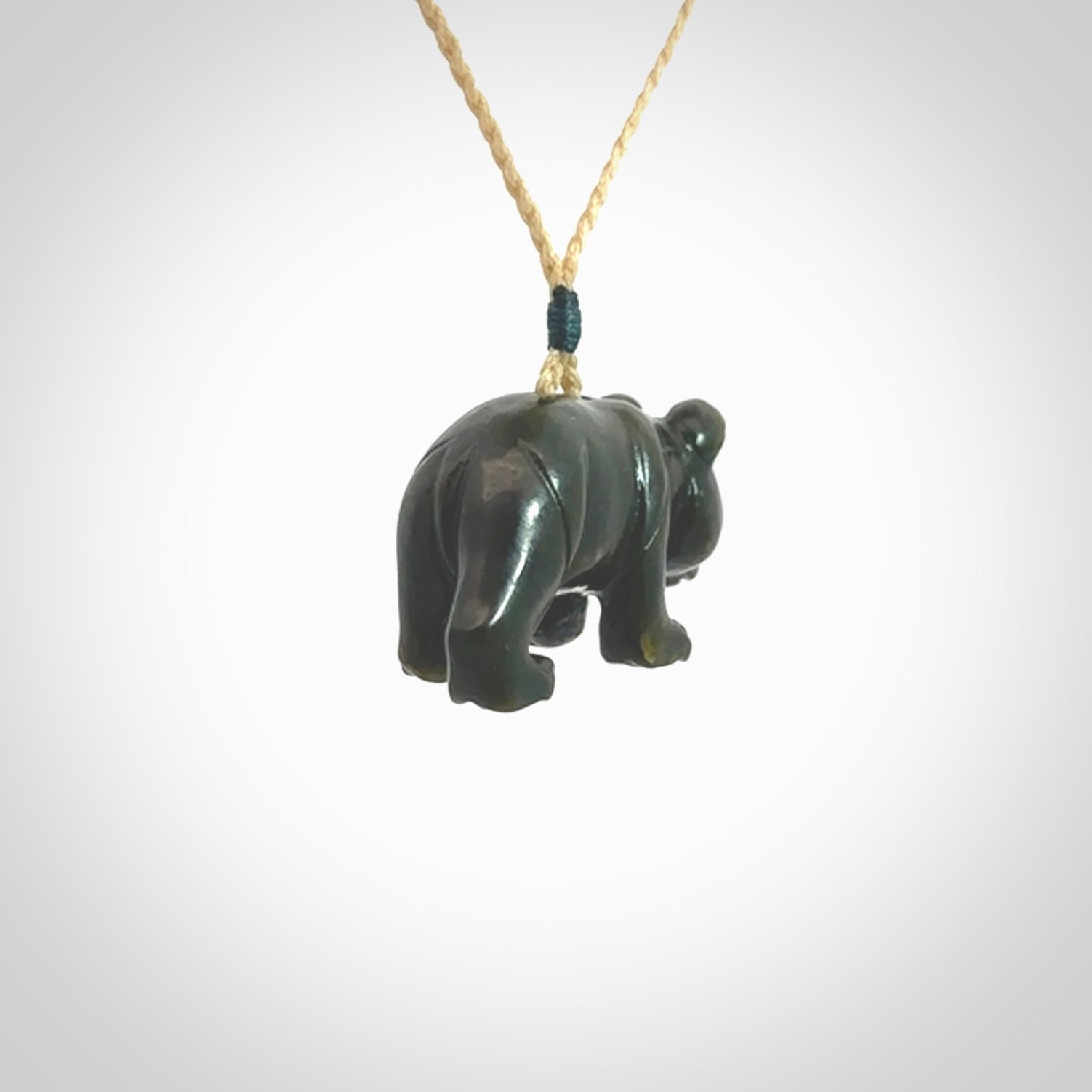 This picture shows a pendant that we designed in New Zealand jade. It is a little green bear that has a walking stance and is carved in detail. A really attractive and eye-catching piece of handmade jewellery. The cord is hand plaited braid and the length can be adjusted.