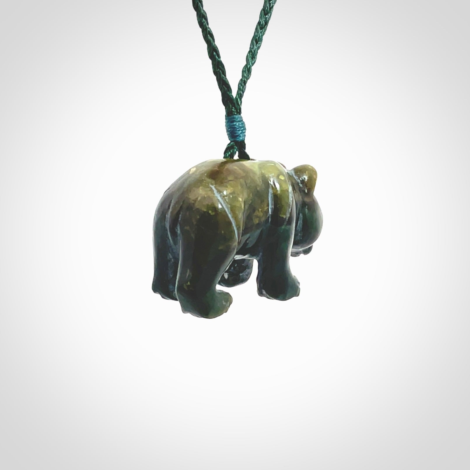 This picture shows a pendant that we designed in New Zealand jade. It is a little green bear that has a walking stance and is carved in detail. A really attractive and eye-catching piece of handmade jewellery. The cord is hand plaited braid in manuka green and the length can be adjusted.