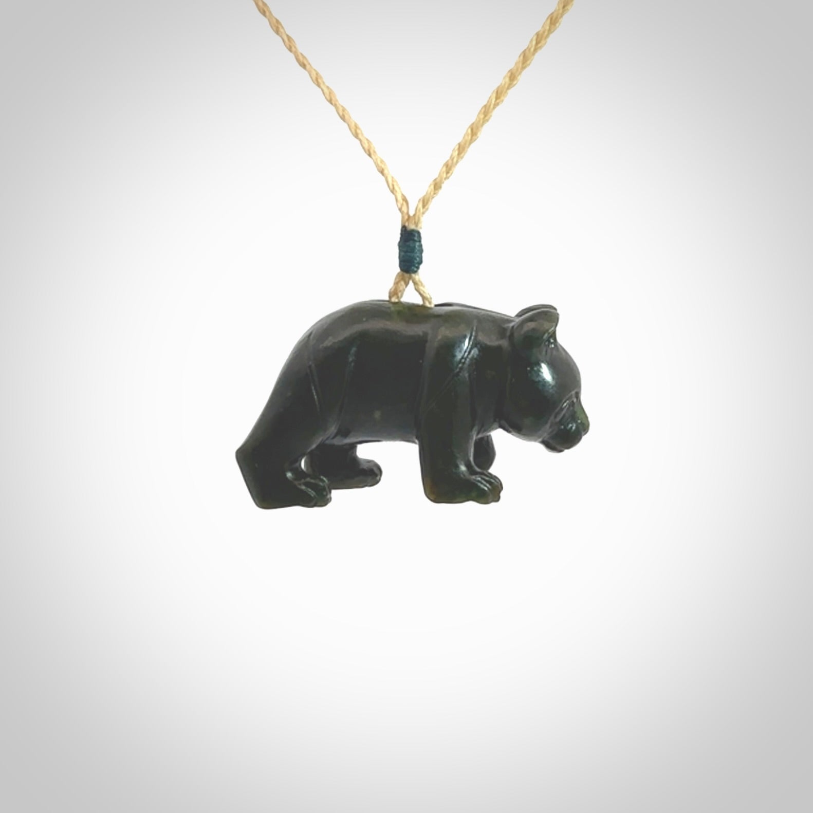 This picture shows a pendant that we designed in New Zealand jade. It is a little green bear that has a walking stance and is carved in detail. A really attractive and eye-catching piece of handmade jewellery. The cord is hand plaited braid and the length can be adjusted.