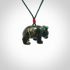 This picture shows a pendant that we designed in New Zealand jade. It is a little green bear that has a walking stance and is carved in detail. A really attractive and eye-catching piece of handmade jewellery. The cord is hand plaited braid in manuka green and the length can be adjusted.