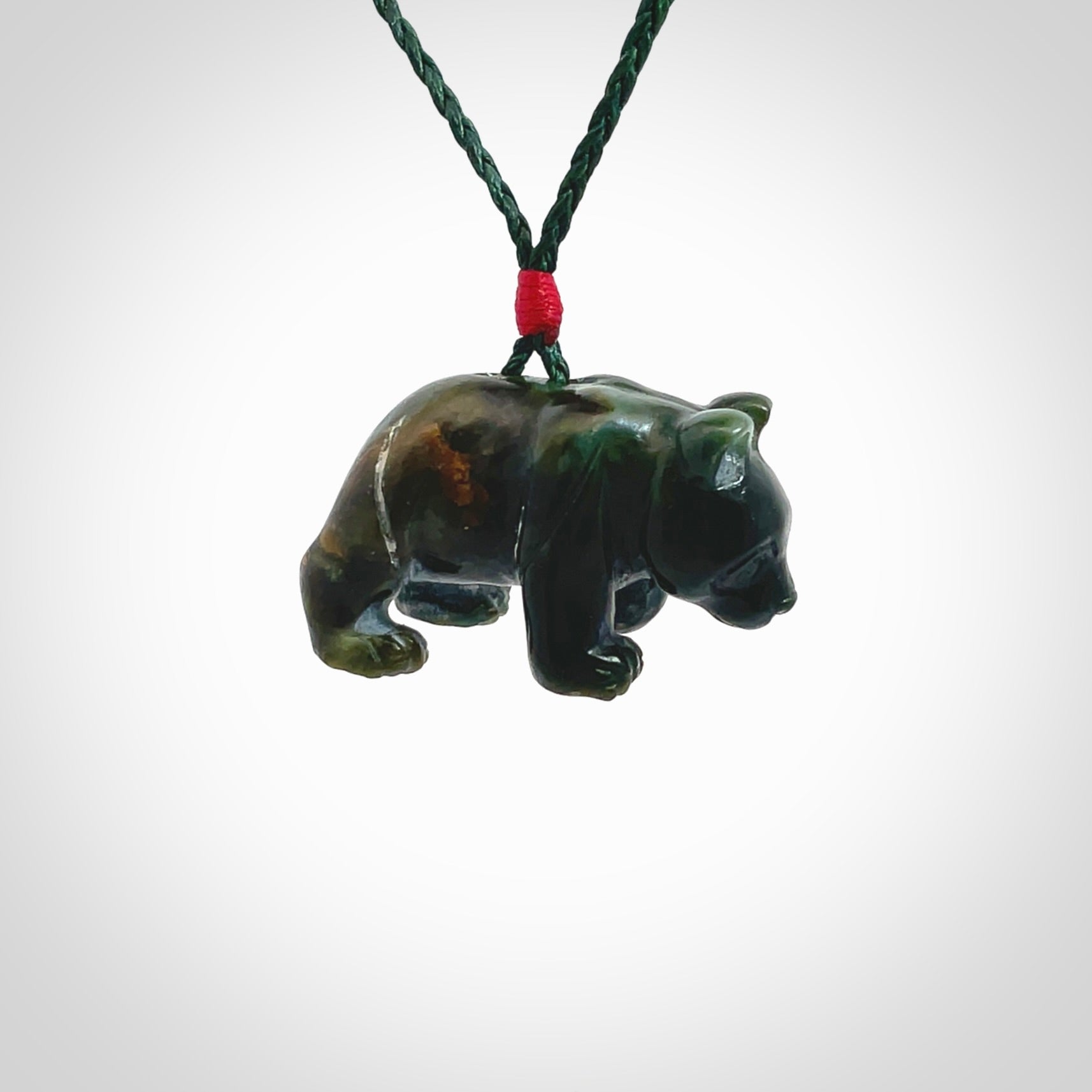 This picture shows a pendant that we designed in New Zealand jade. It is a little green bear that has a walking stance and is carved in detail. A really attractive and eye-catching piece of handmade jewellery. The cord is hand plaited braid in manuka green and the length can be adjusted.