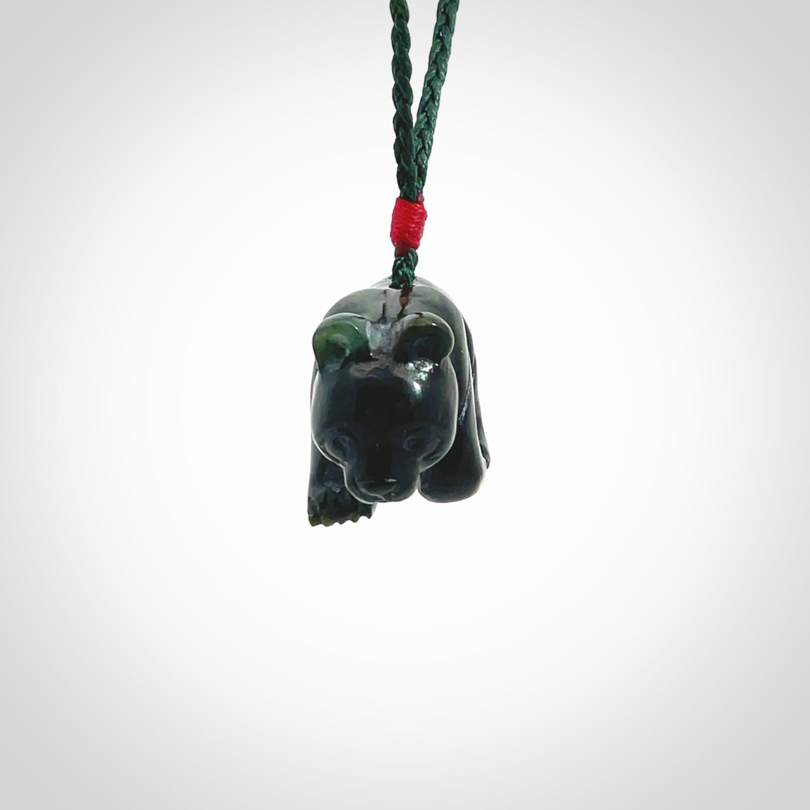 This picture shows a pendant that we designed in New Zealand jade. It is a little green bear that has a walking stance and is carved in detail. A really attractive and eye-catching piece of handmade jewellery. The cord is hand plaited braid in manuka green and the length can be adjusted.