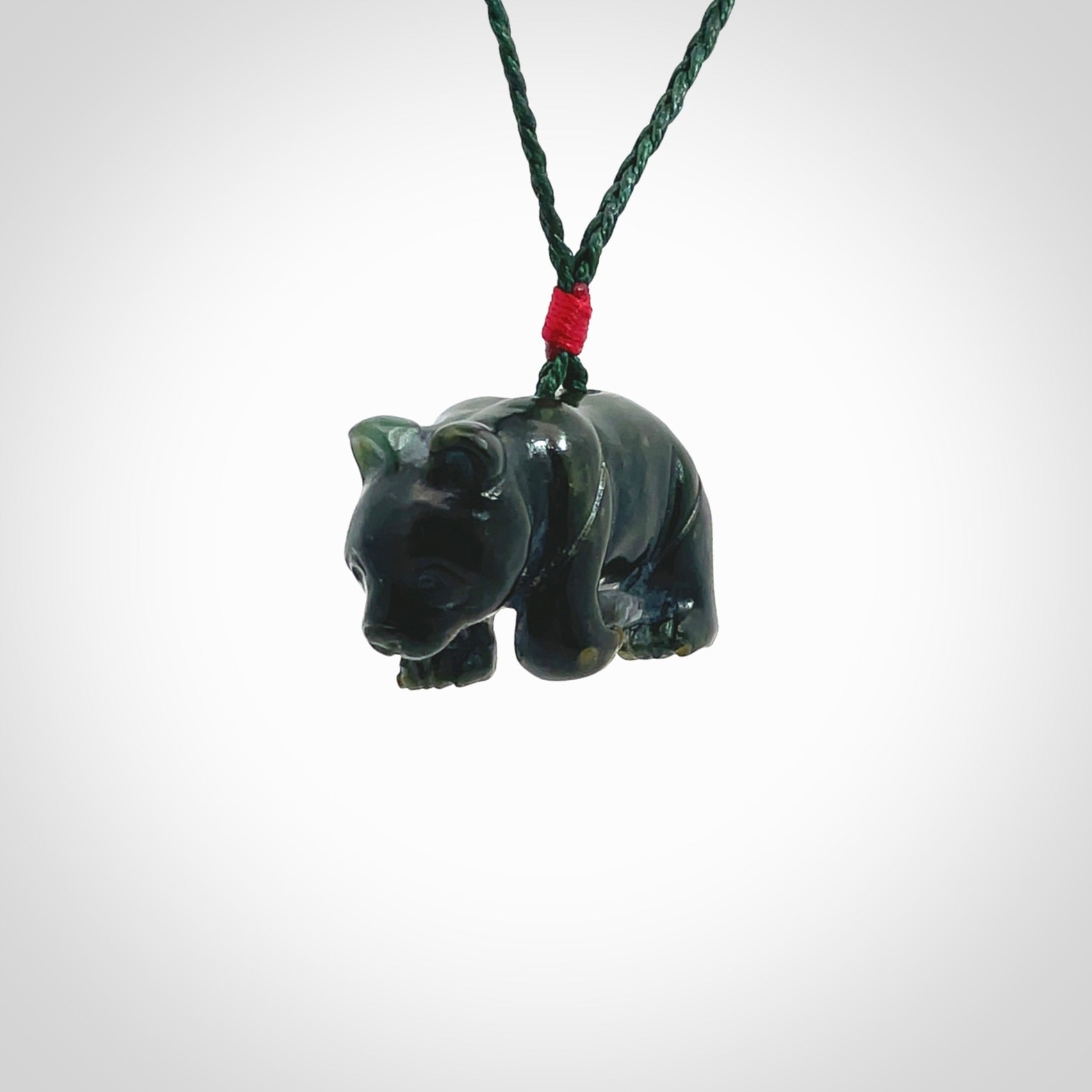 This picture shows a pendant that we designed in New Zealand jade. It is a little green bear that has a walking stance and is carved in detail. A really attractive and eye-catching piece of handmade jewellery. The cord is hand plaited braid in manuka green and the length can be adjusted.