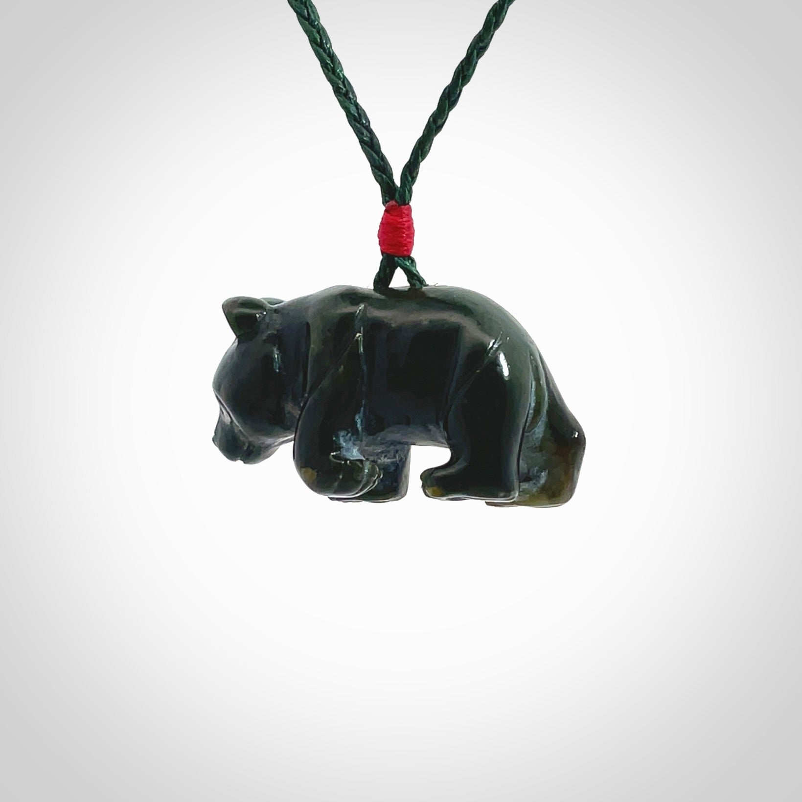 This picture shows a pendant that we designed in New Zealand jade. It is a little green bear that has a walking stance and is carved in detail. A really attractive and eye-catching piece of handmade jewellery. The cord is hand plaited braid in manuka green and the length can be adjusted.