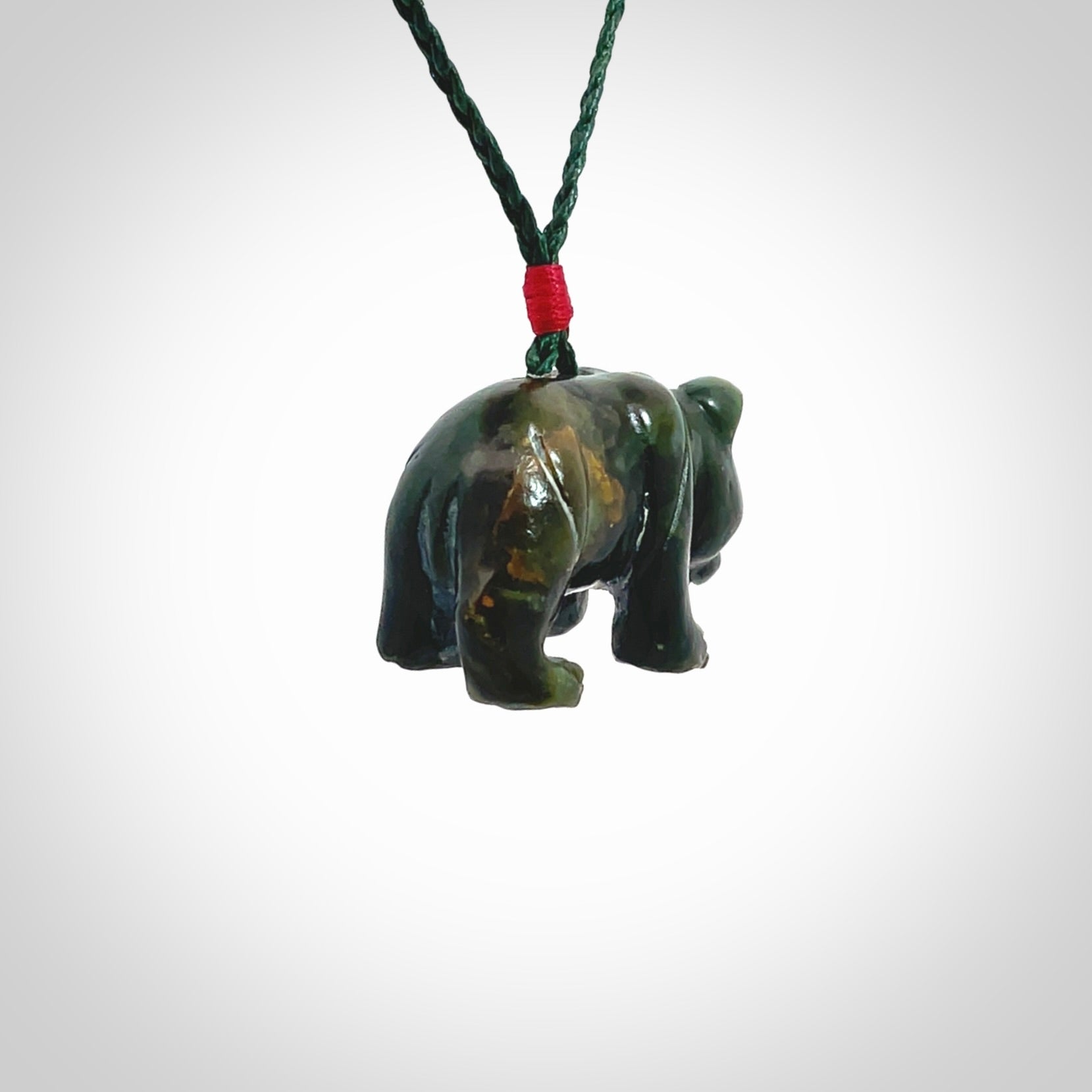 This picture shows a pendant that we designed in New Zealand jade. It is a little green bear that has a walking stance and is carved in detail. A really attractive and eye-catching piece of handmade jewellery. The cord is hand plaited braid in manuka green and the length can be adjusted.