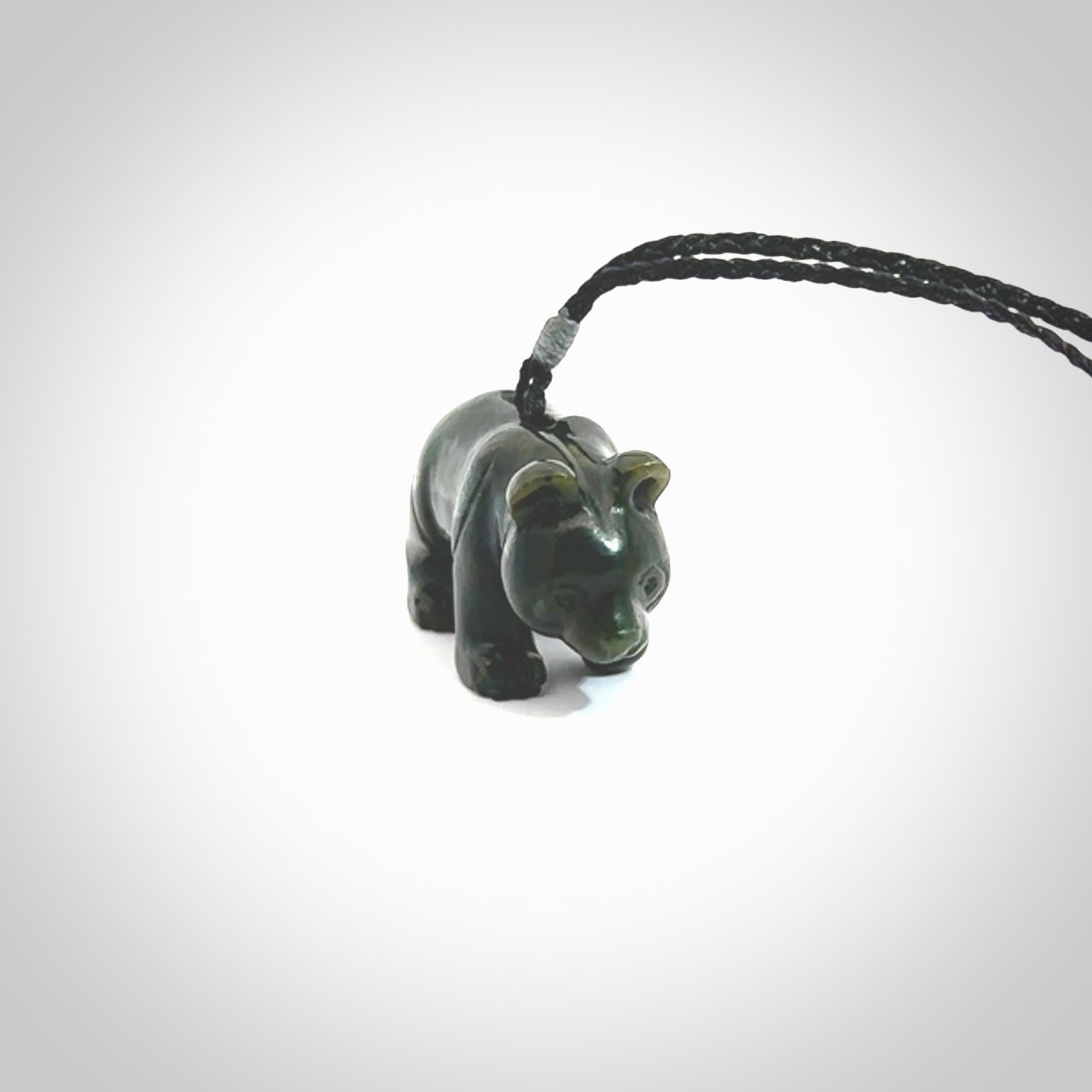 This picture shows a pendant that we designed in New Zealand jade. It is a little green bear that has a walking stance and is carved in detail. A really attractive and eye-catching piece of handmade jewellery. The cord is hand plaited braid and the length can be adjusted.