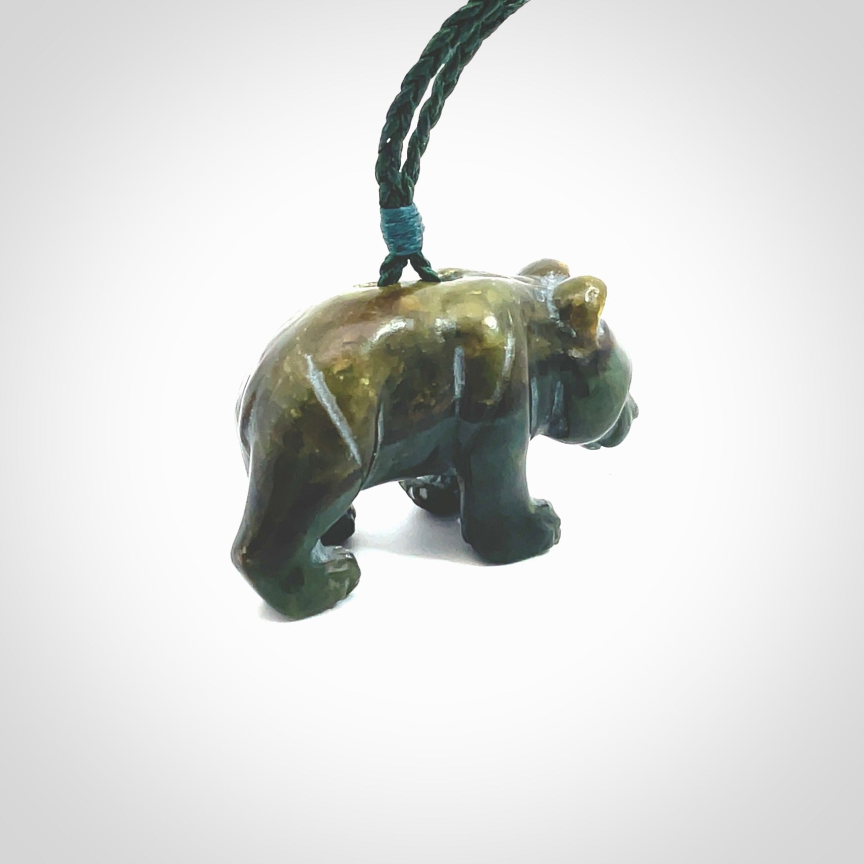 This picture shows a pendant that we designed in New Zealand jade. It is a little green bear that has a walking stance and is carved in detail. A really attractive and eye-catching piece of handmade jewellery. The cord is hand plaited braid in manuka green and the length can be adjusted.