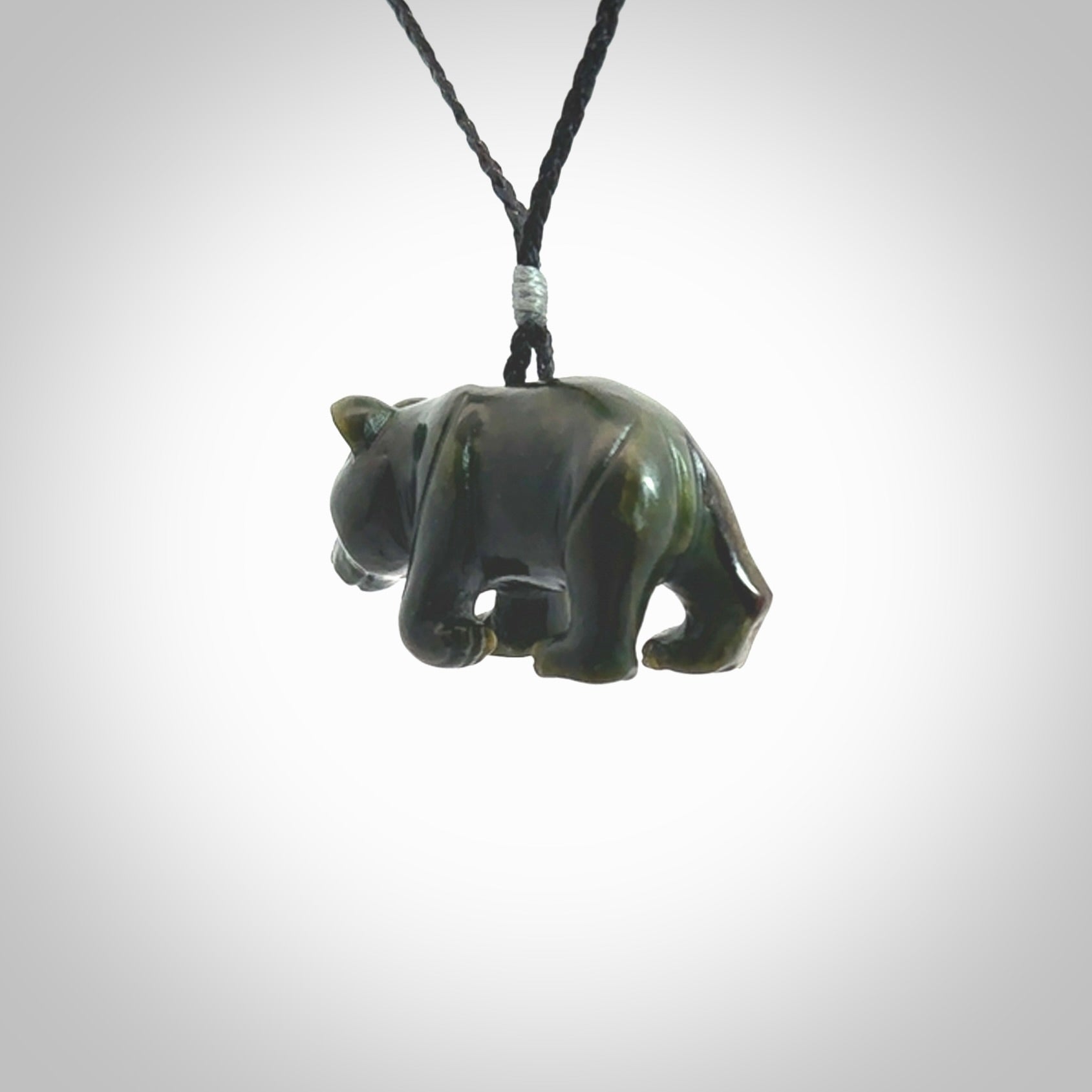 This picture shows a pendant that we designed in New Zealand jade. It is a little green bear that has a walking stance and is carved in detail. A really attractive and eye-catching piece of handmade jewellery. The cord is hand plaited braid and the length can be adjusted.